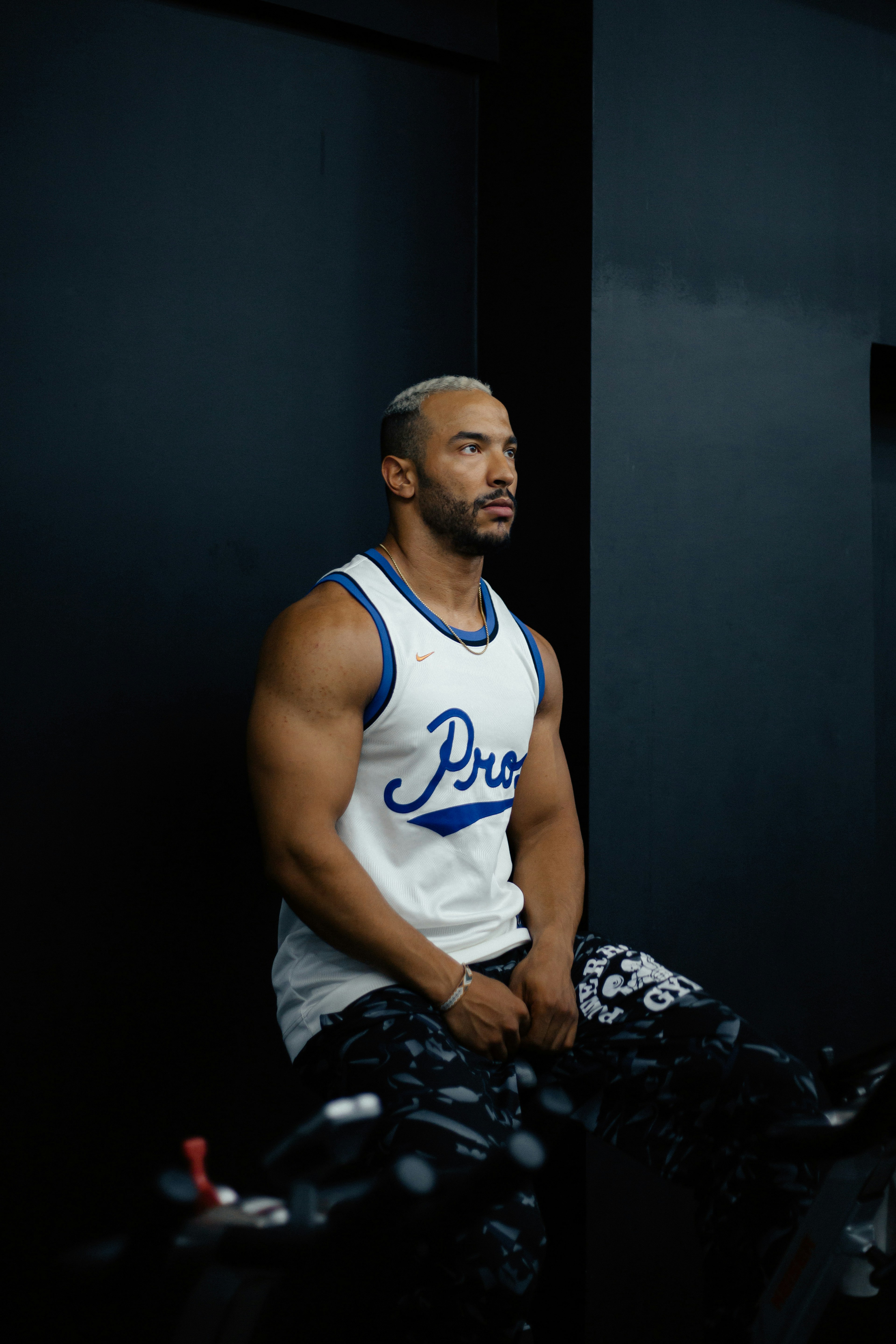 A man sitting on a bench in a gym