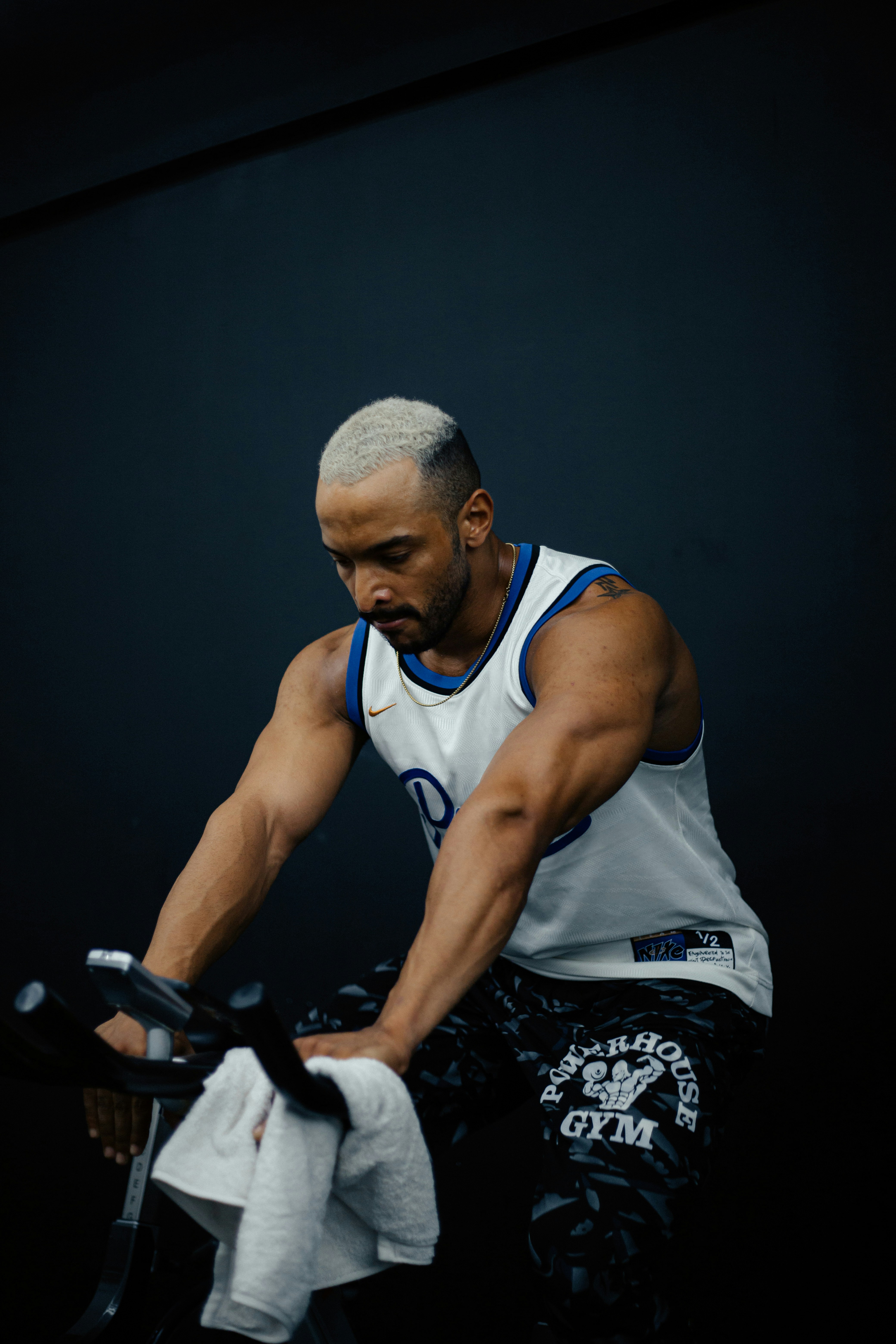 A man riding a bike while holding a towel