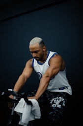 A man riding a bike while holding a towel