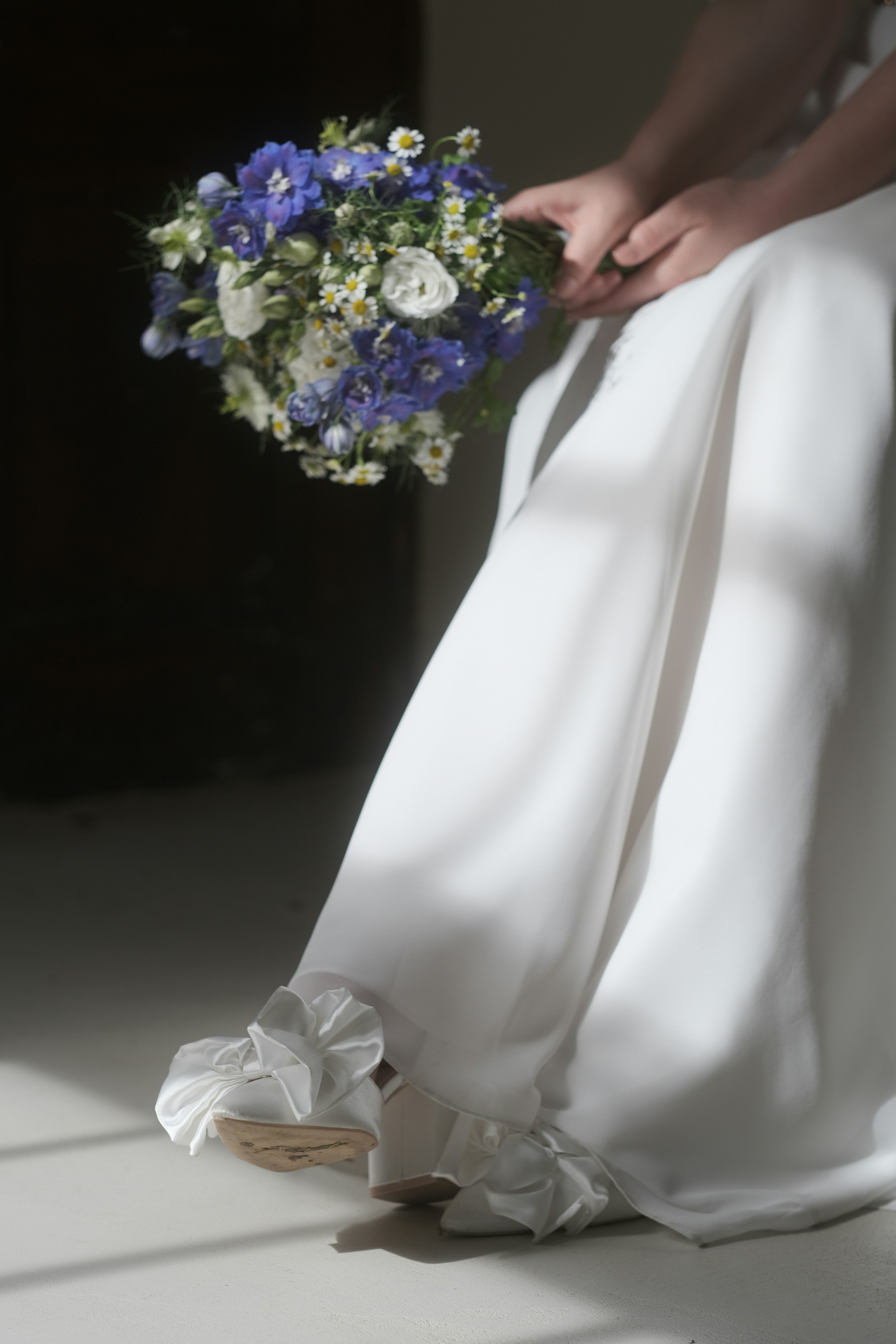 A woman in a white dress holding a bouquet of flowers
