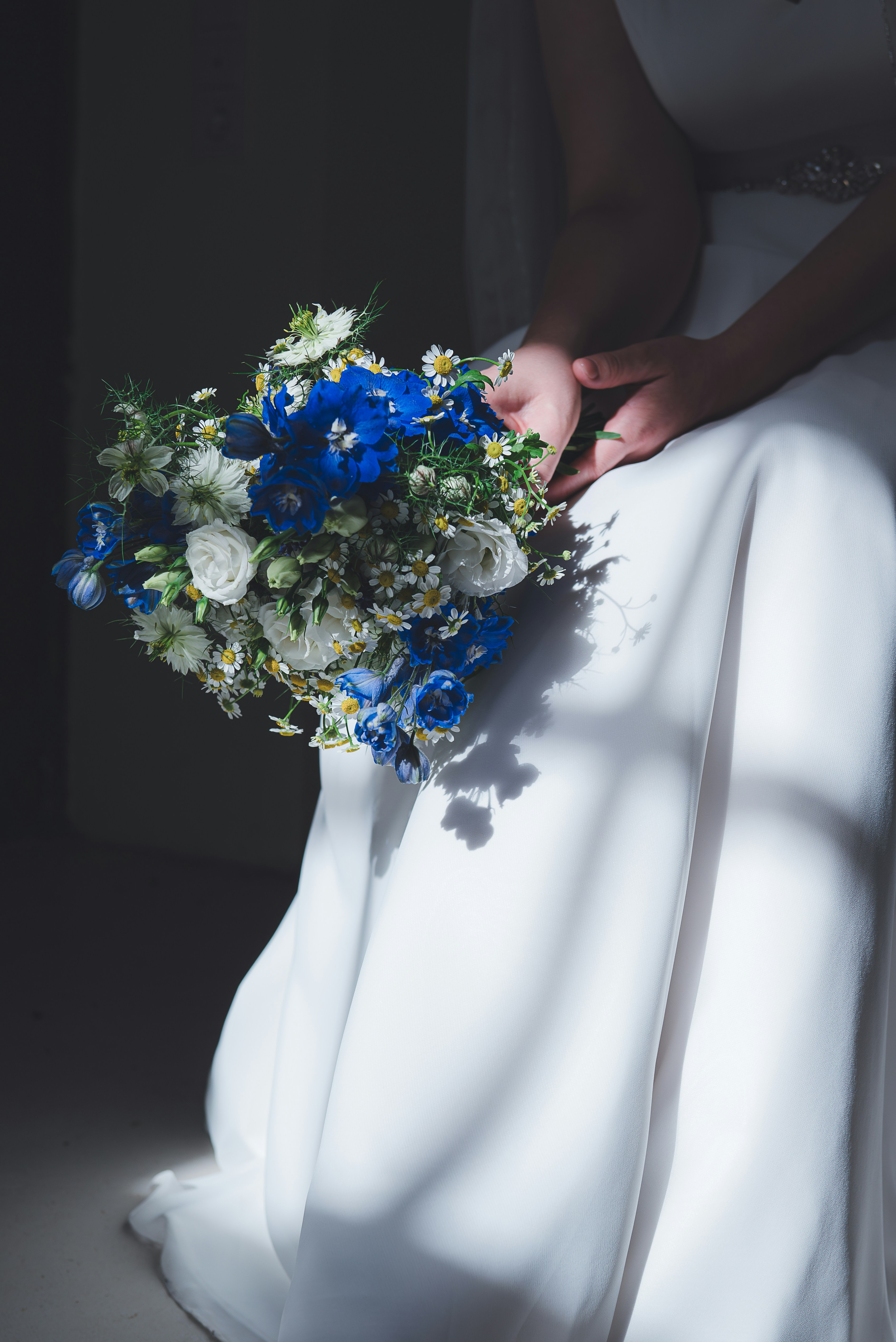 A woman in a white dress holding a bouquet of flowers