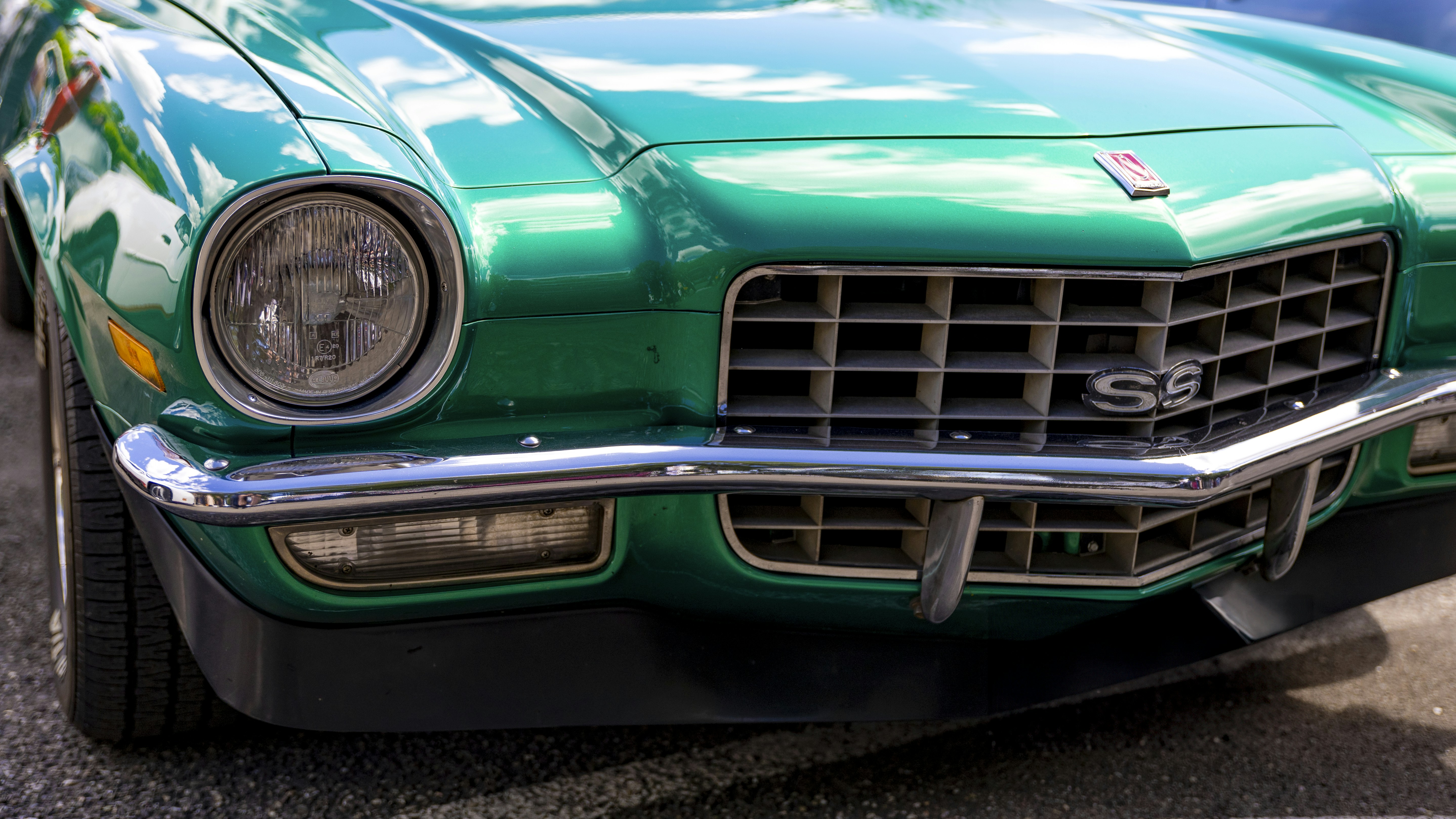 A green car parked on the side of the road