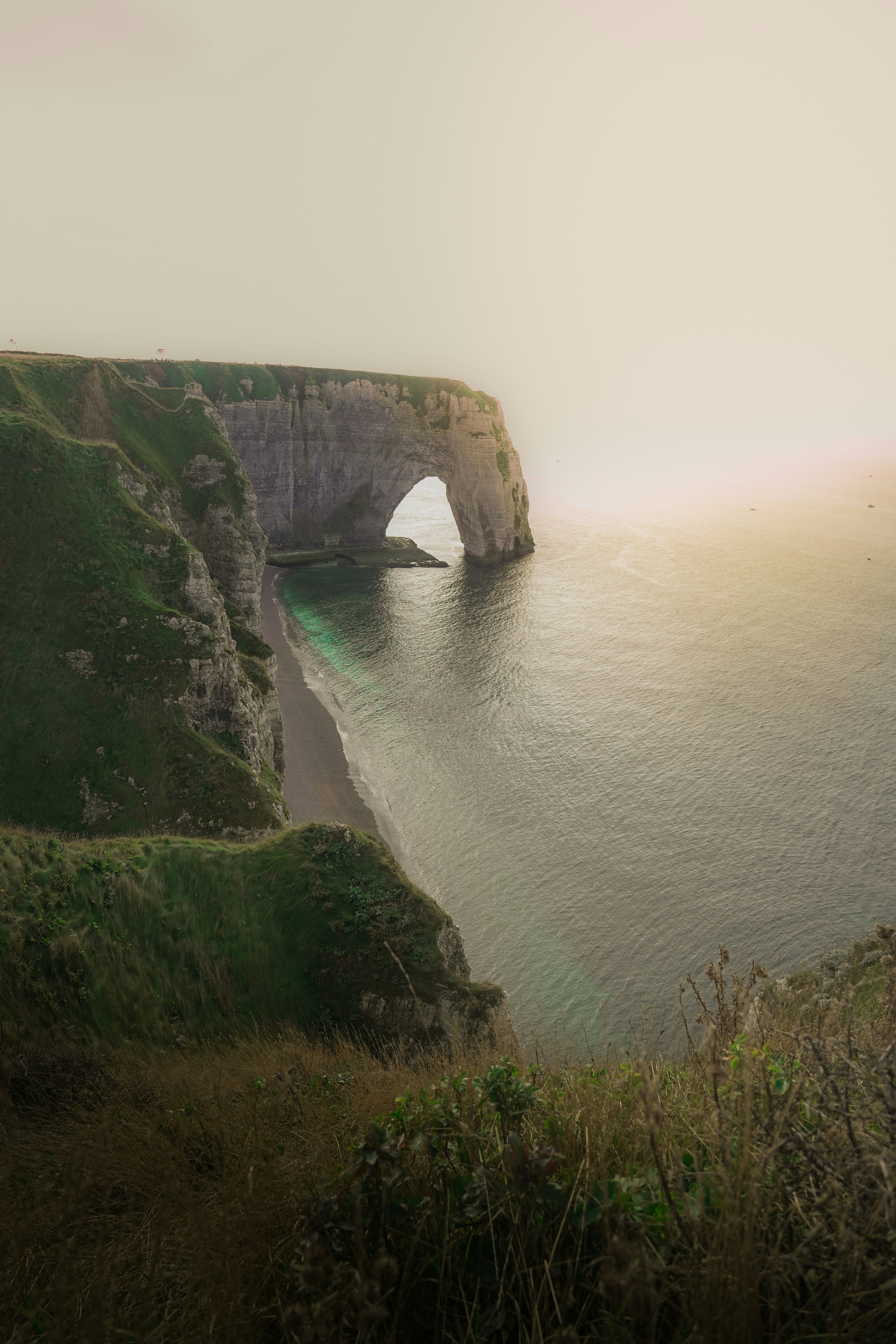 A large body of water near a cliff