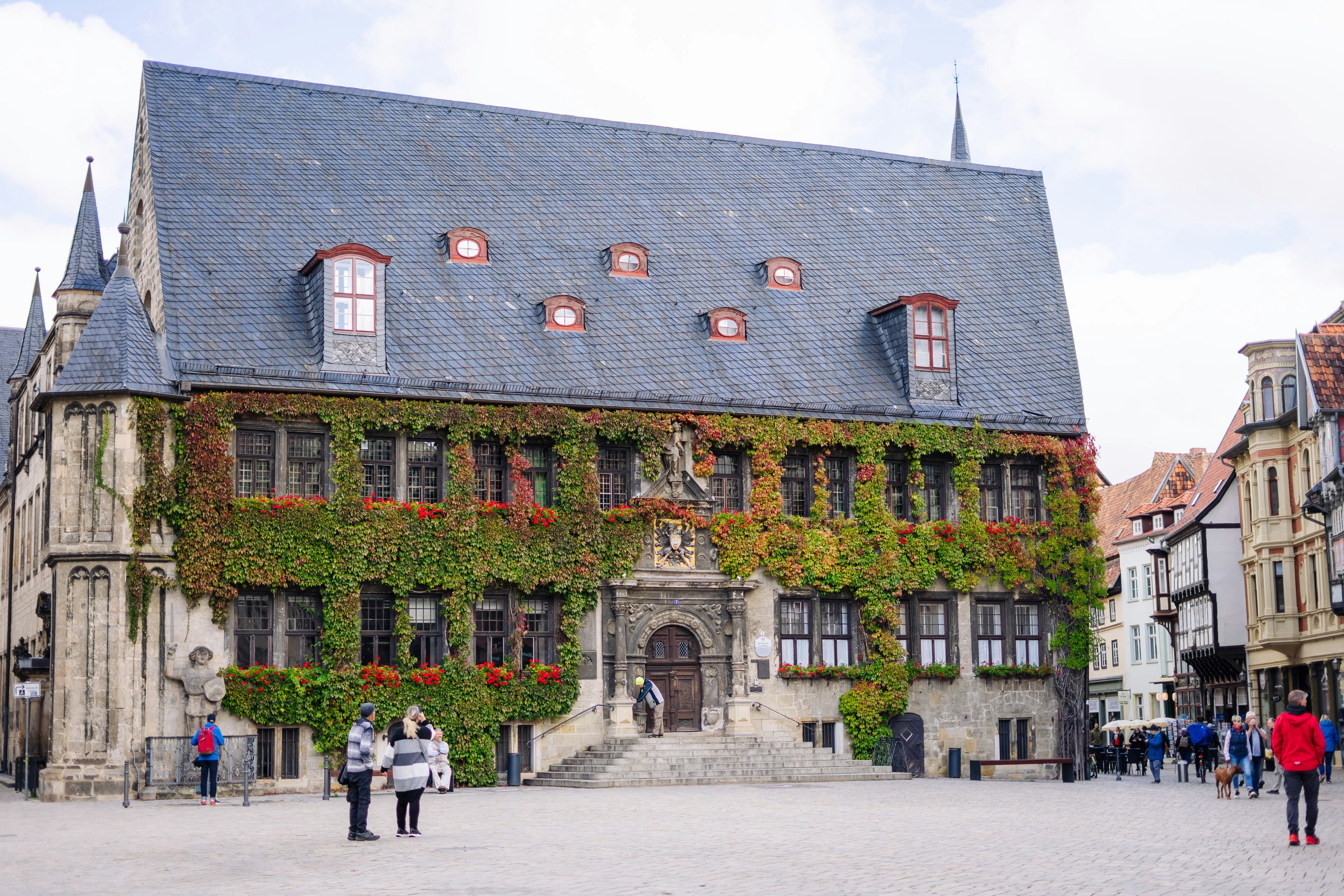 A group of people walking around a large building