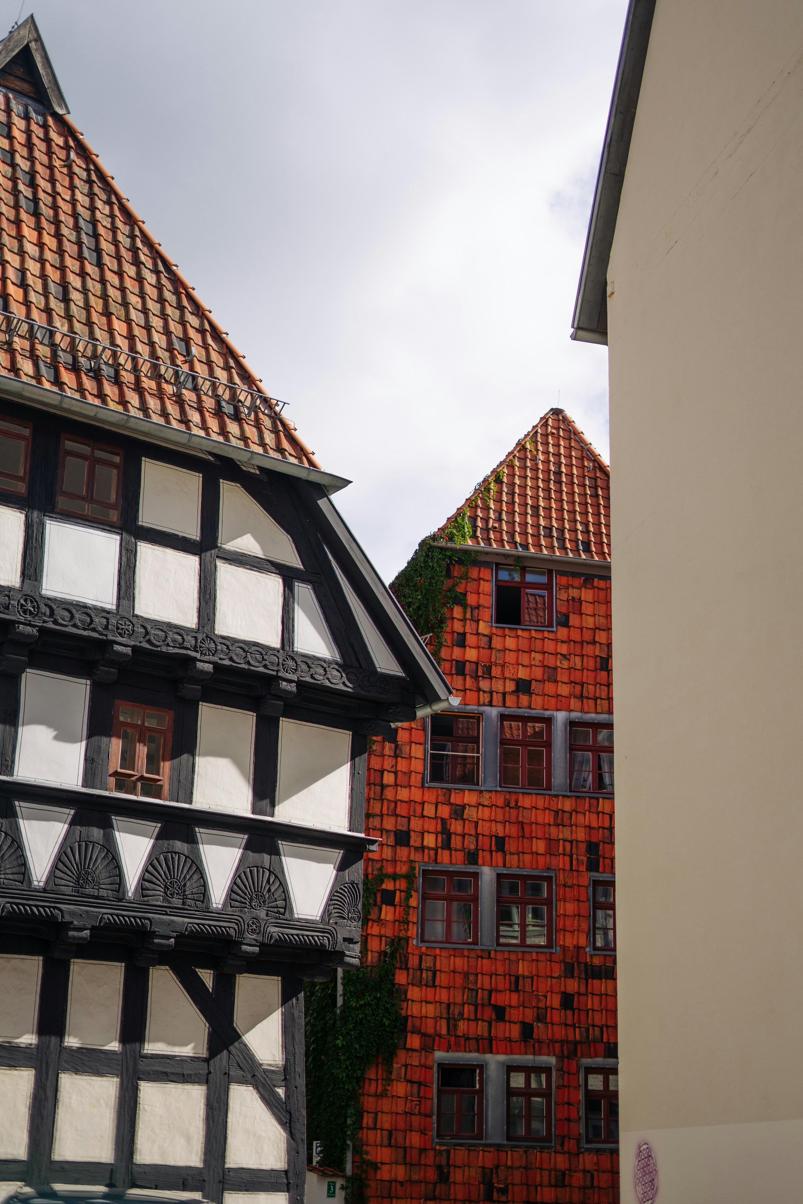 A black and white building with a red roof