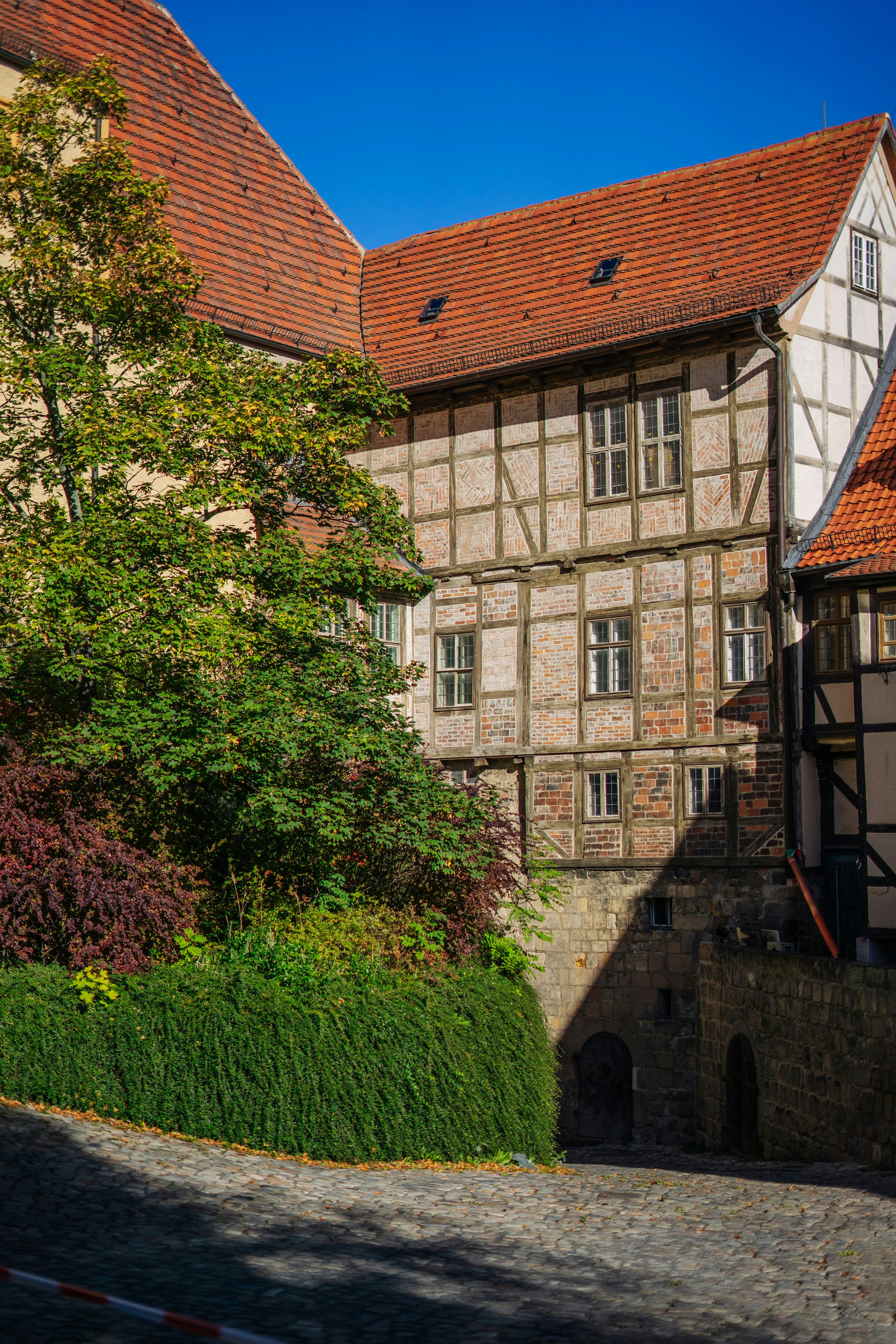 An old building with a red roof and some trees