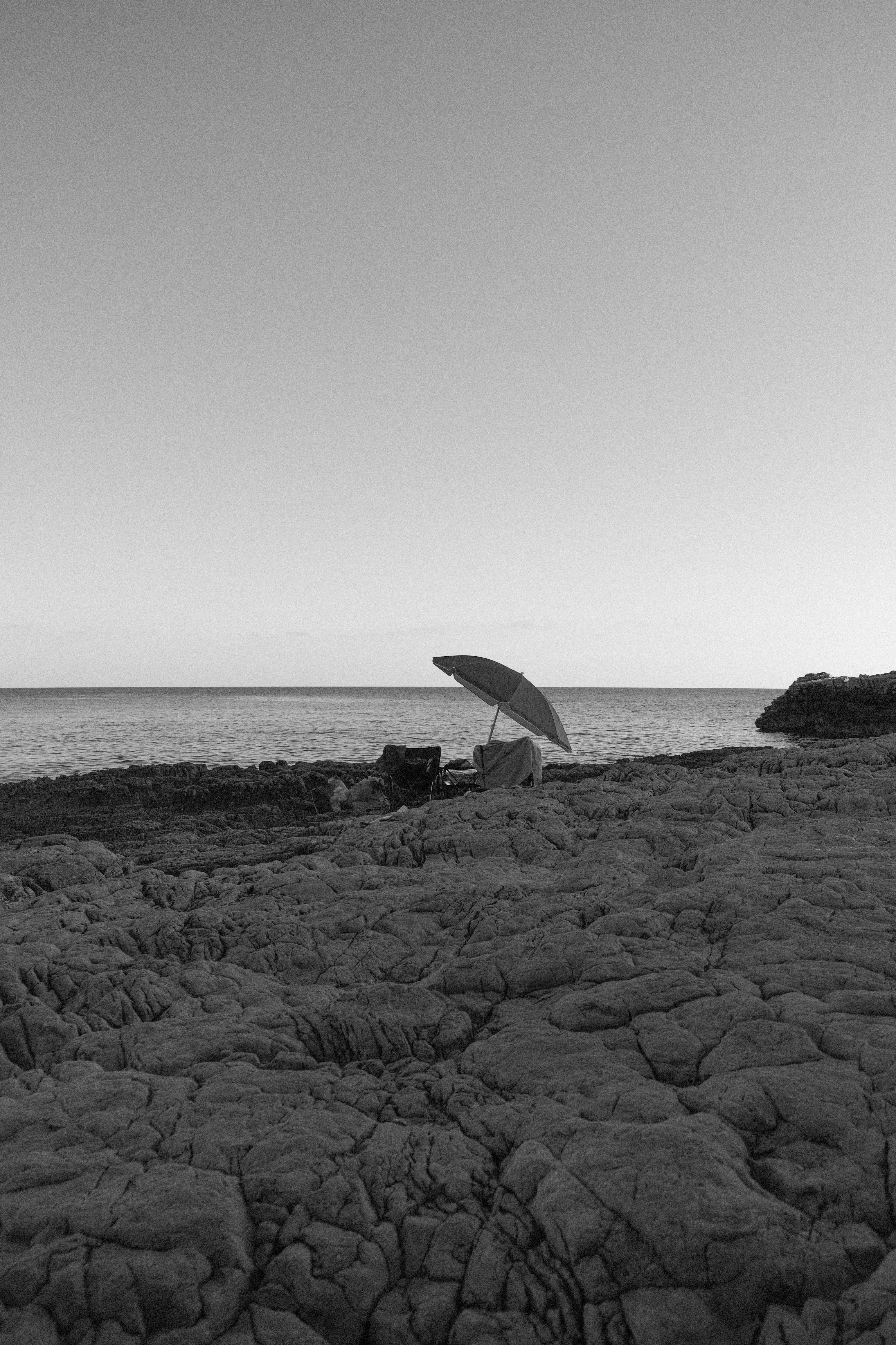 A black and white photo of a person with an umbrella
