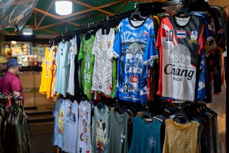 A man standing in front of a display of shirts