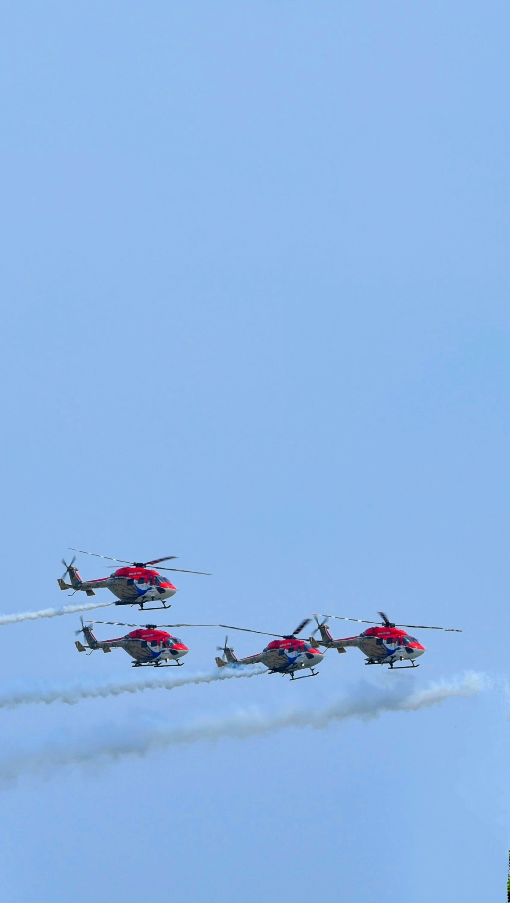 A group of airplanes flying through a blue sky