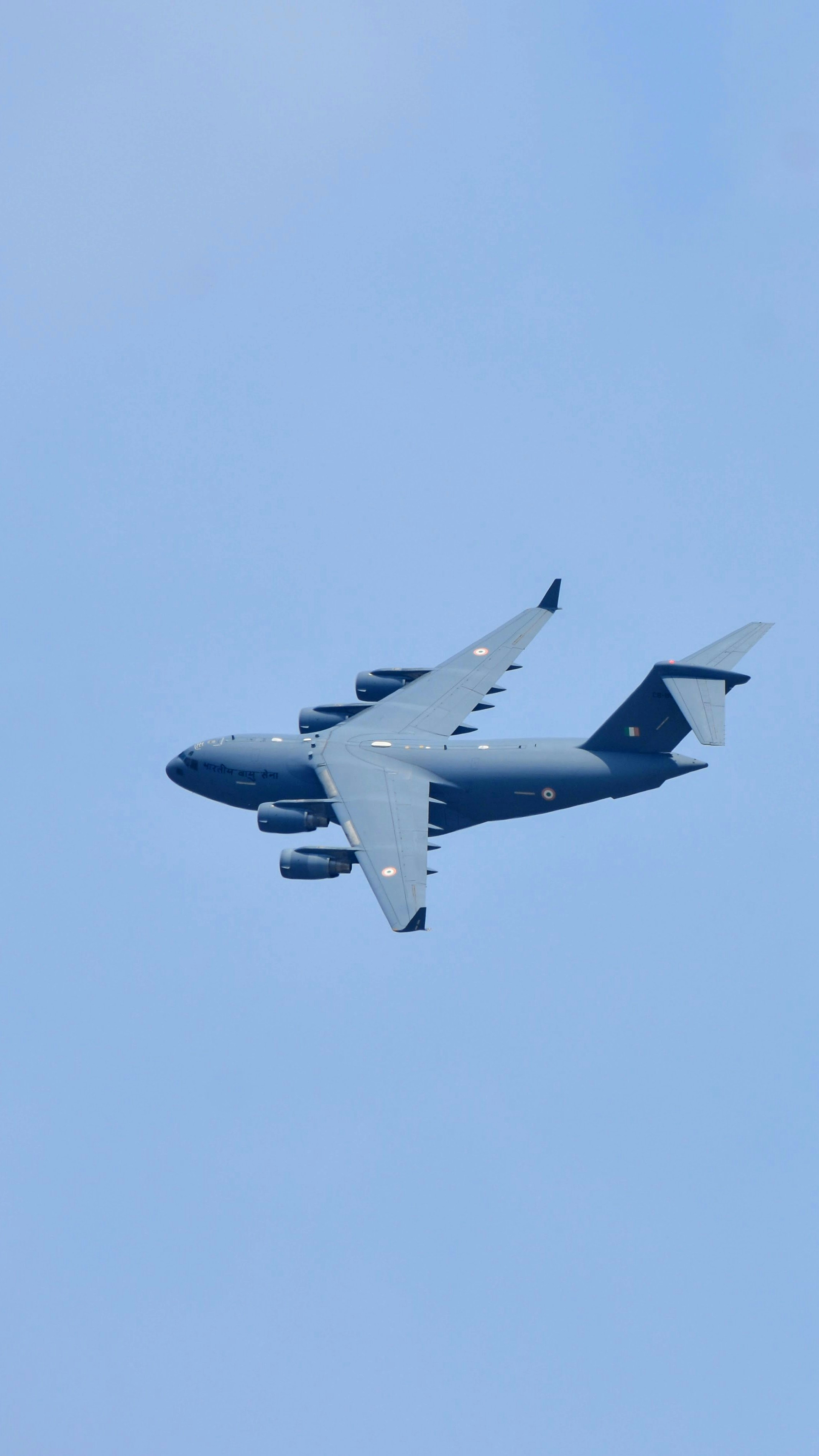 A large jetliner flying through a blue sky