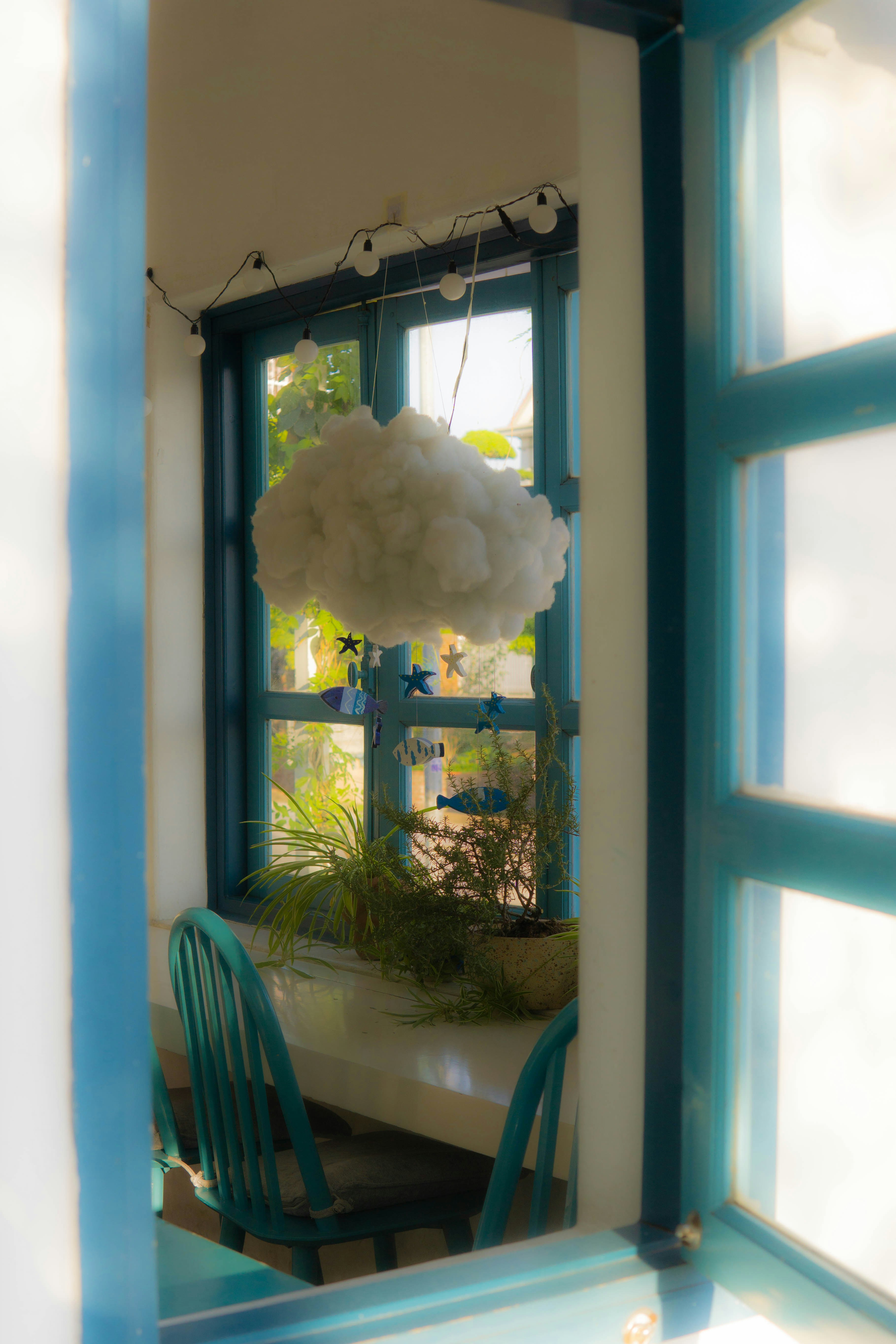 A room with a table, chairs, and a window