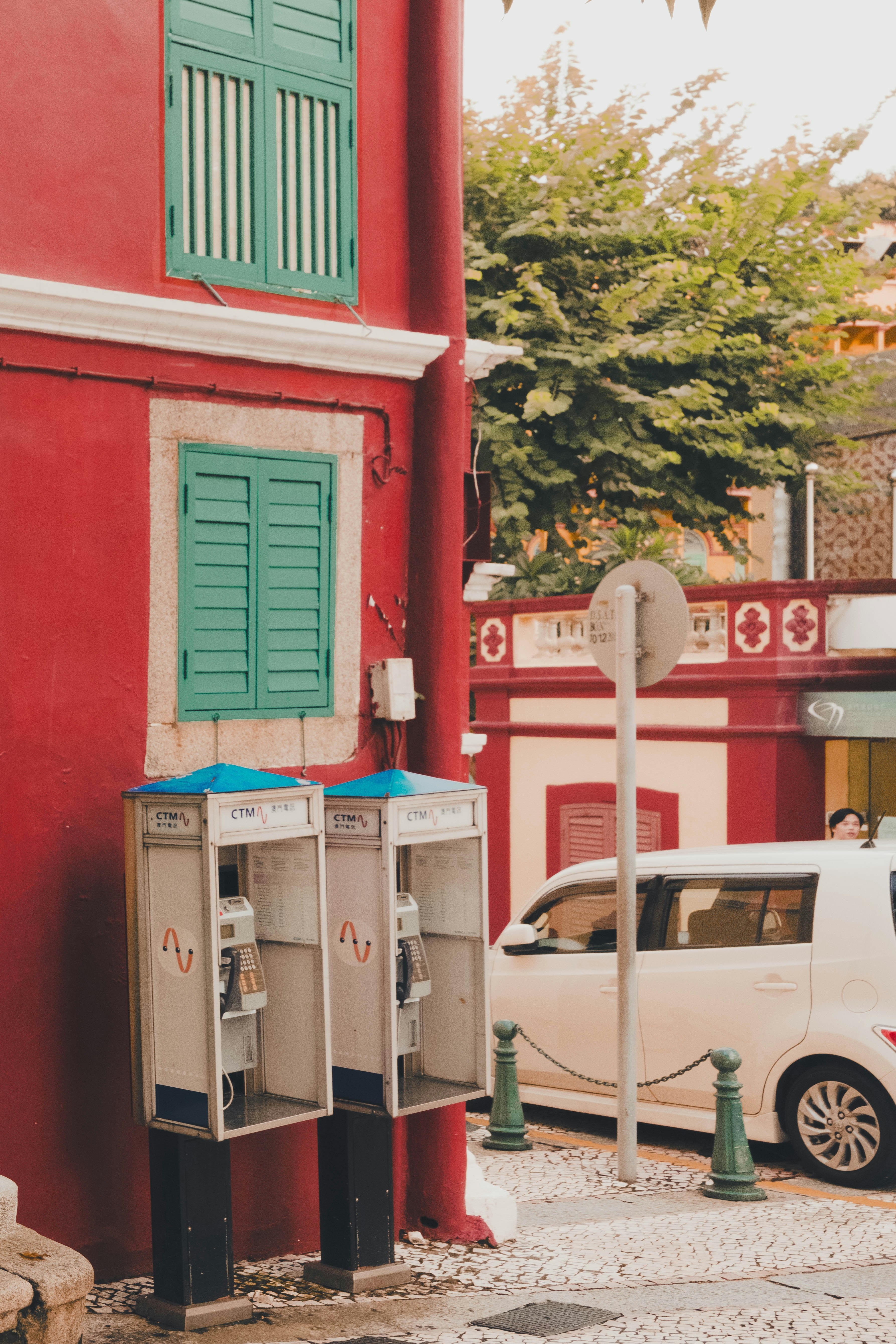 A car parked in front of a red building