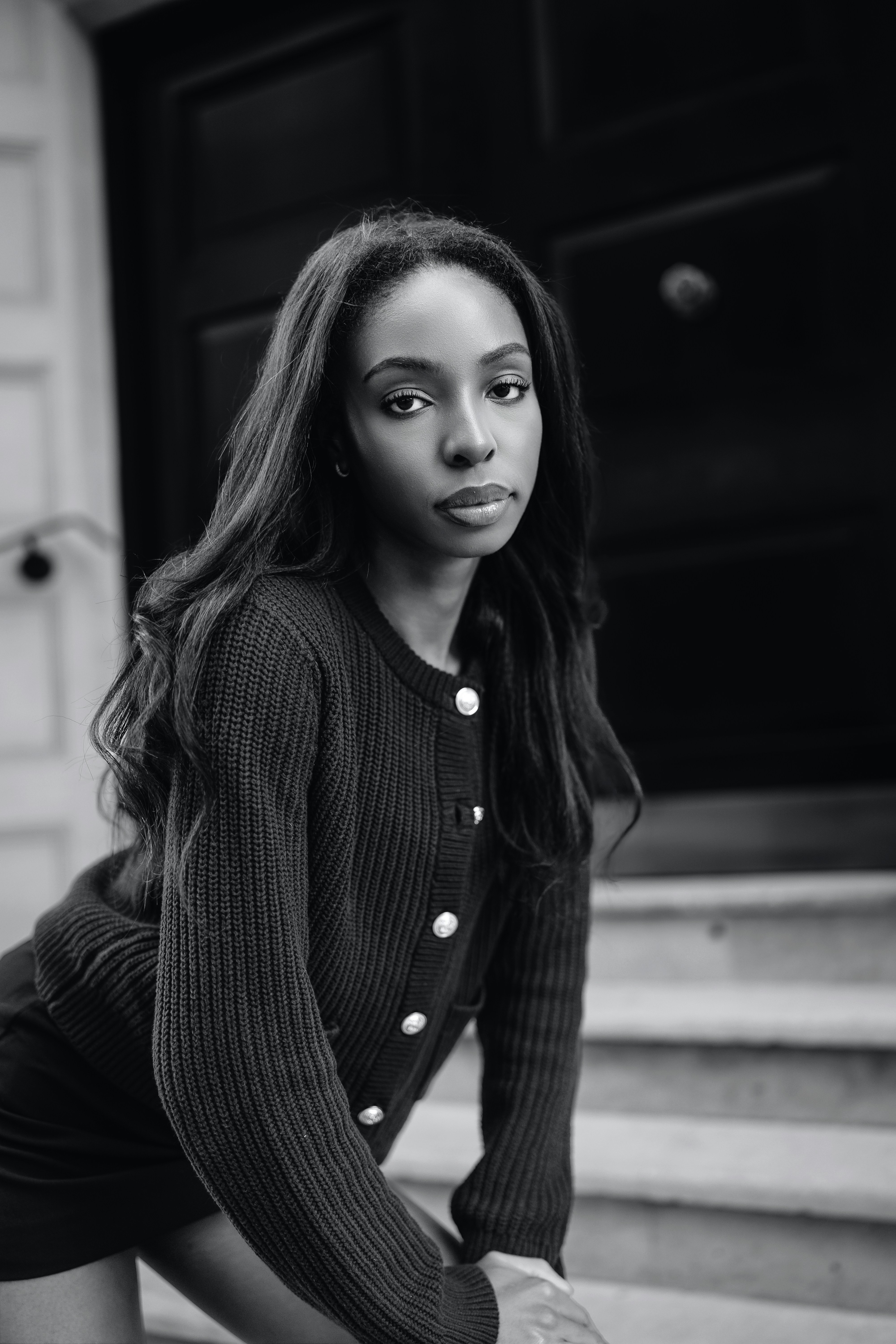 A woman sitting on the steps of a building