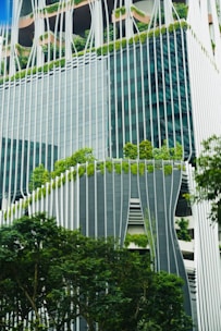 A very tall building with a bunch of trees in front of it