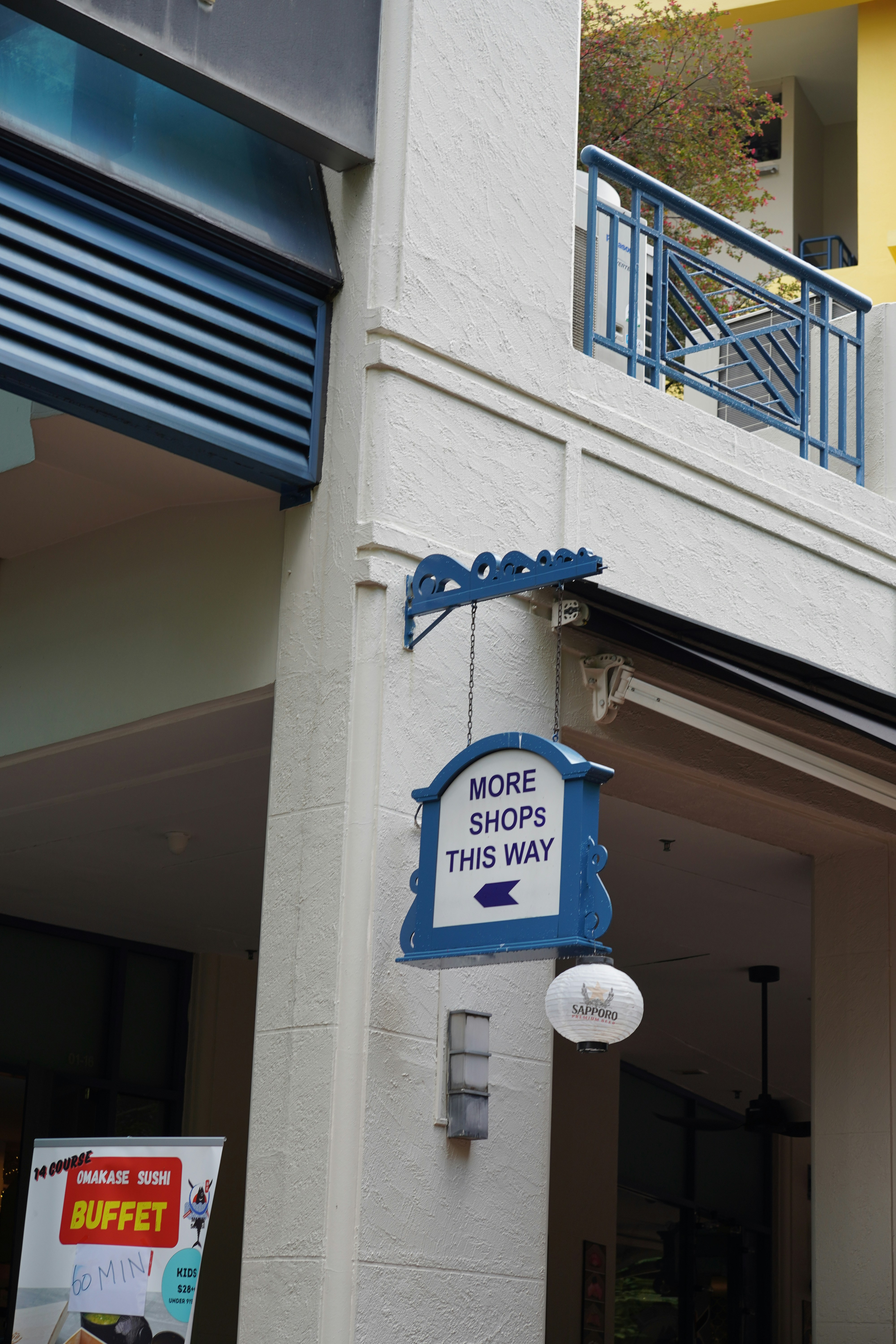A building with a sign that says store shops this way photo – Free ...