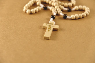 A rosary with a wooden cross on it