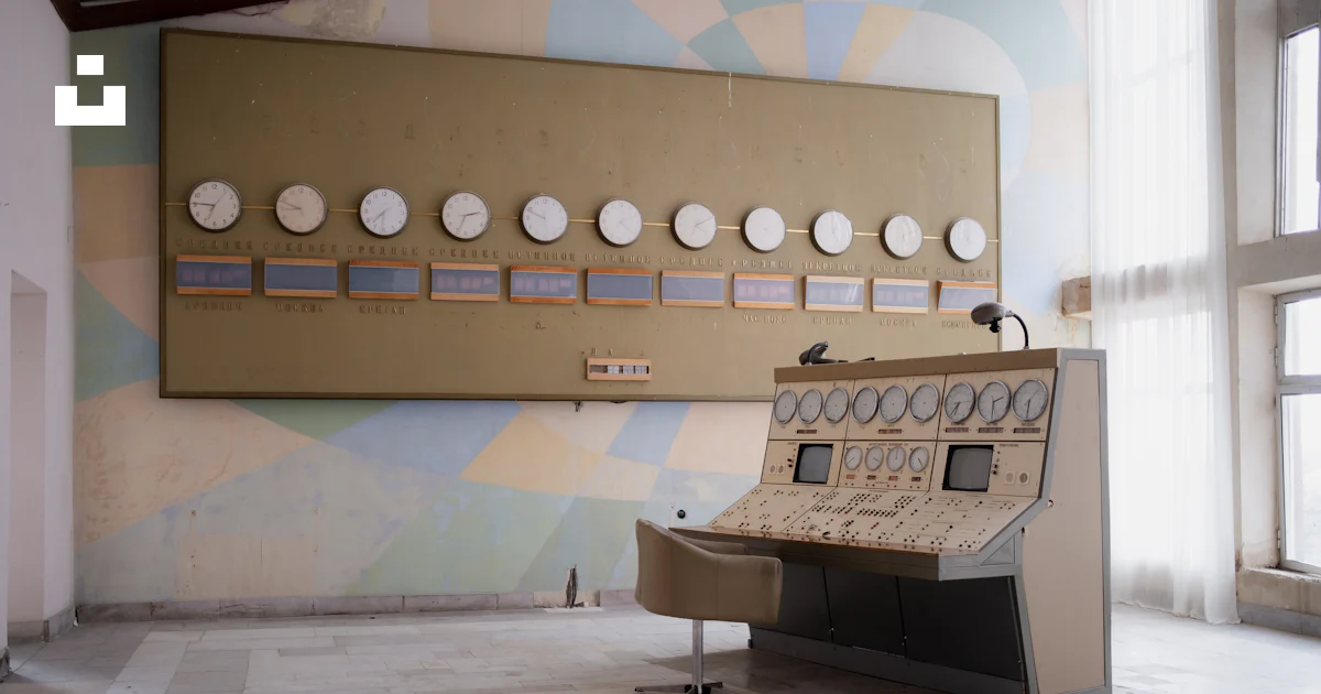 A room with a large wall mounted clock and a piano photo – Free Control ...