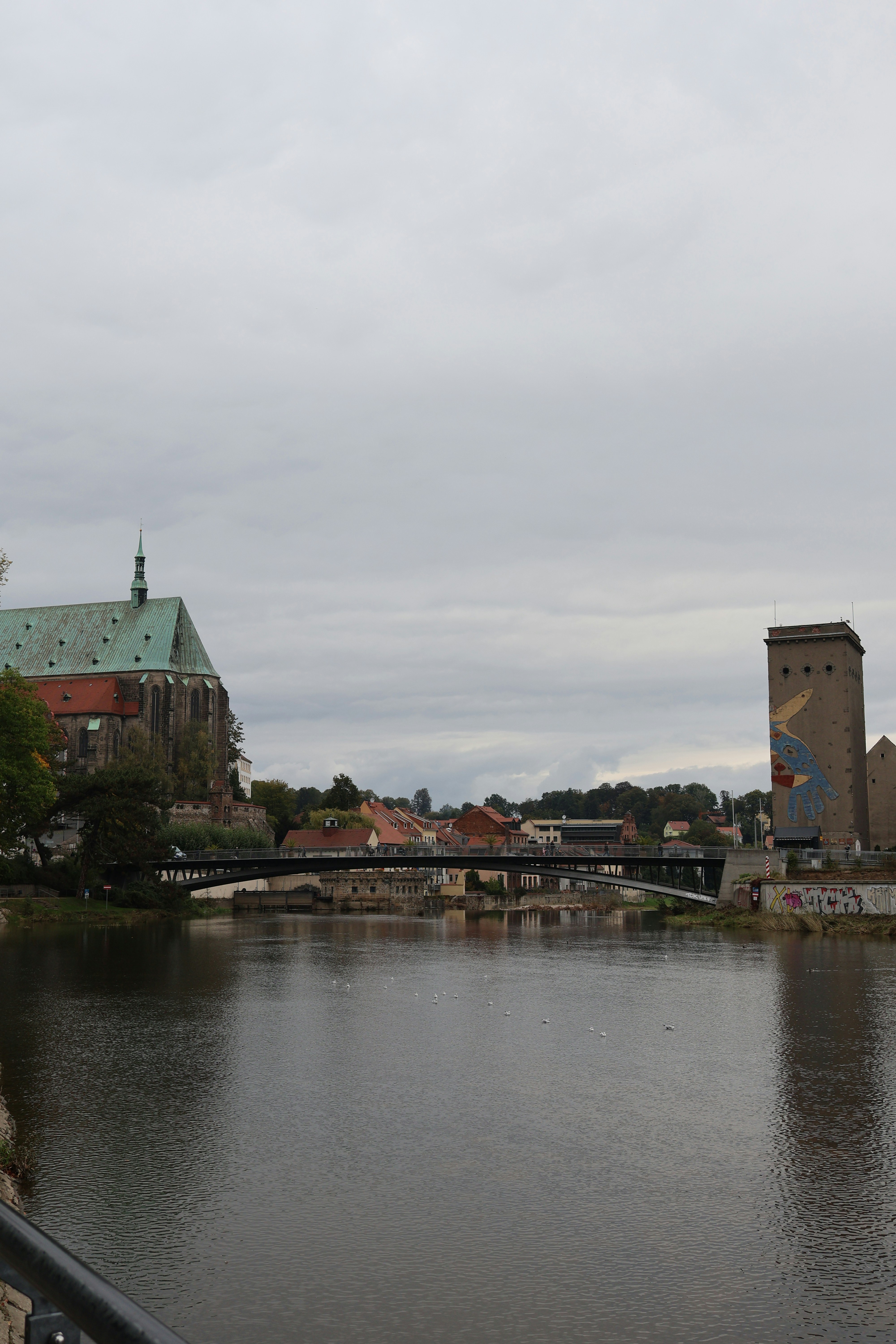 A large body of water with a bridge in the background