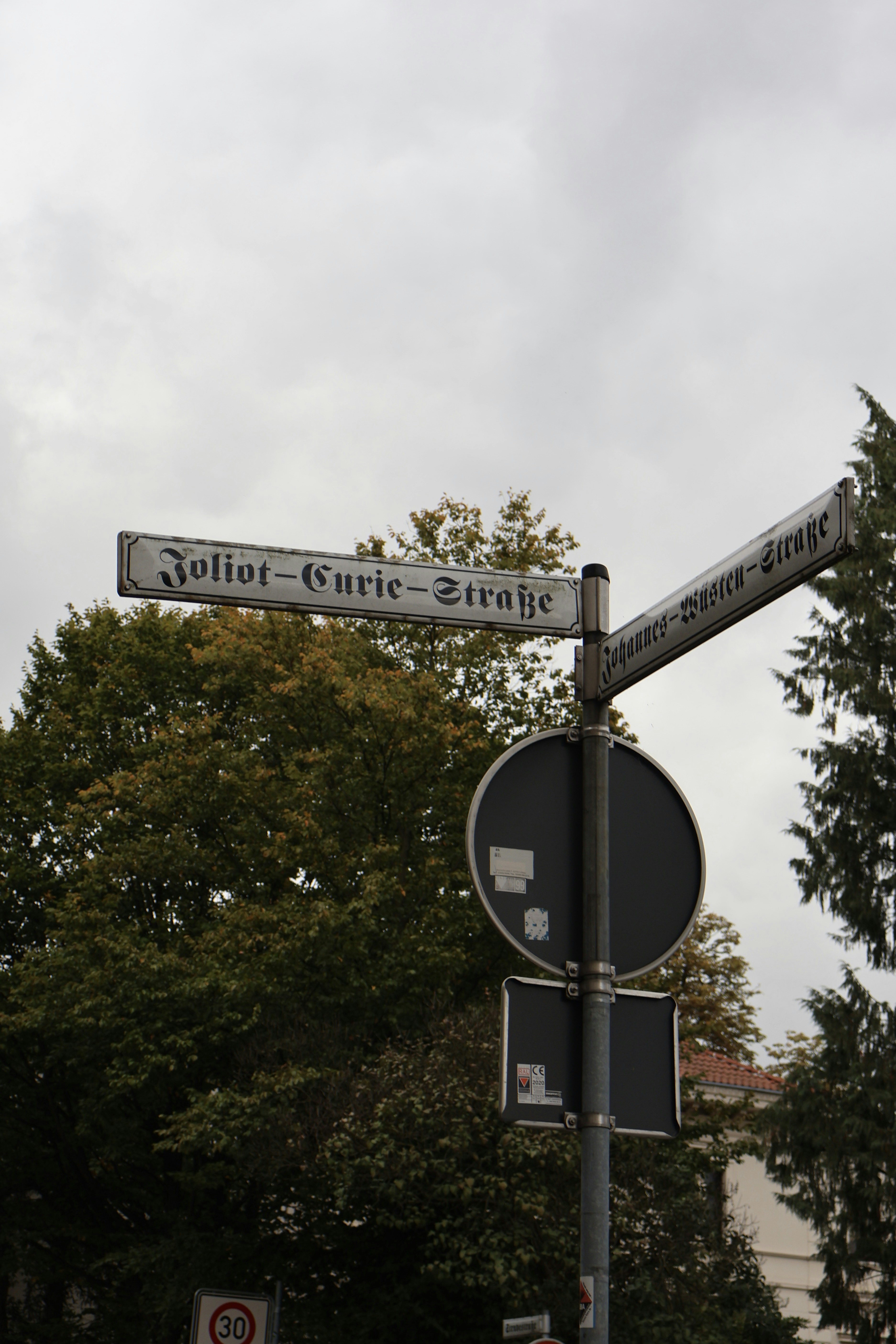 A street sign on a pole on a city street