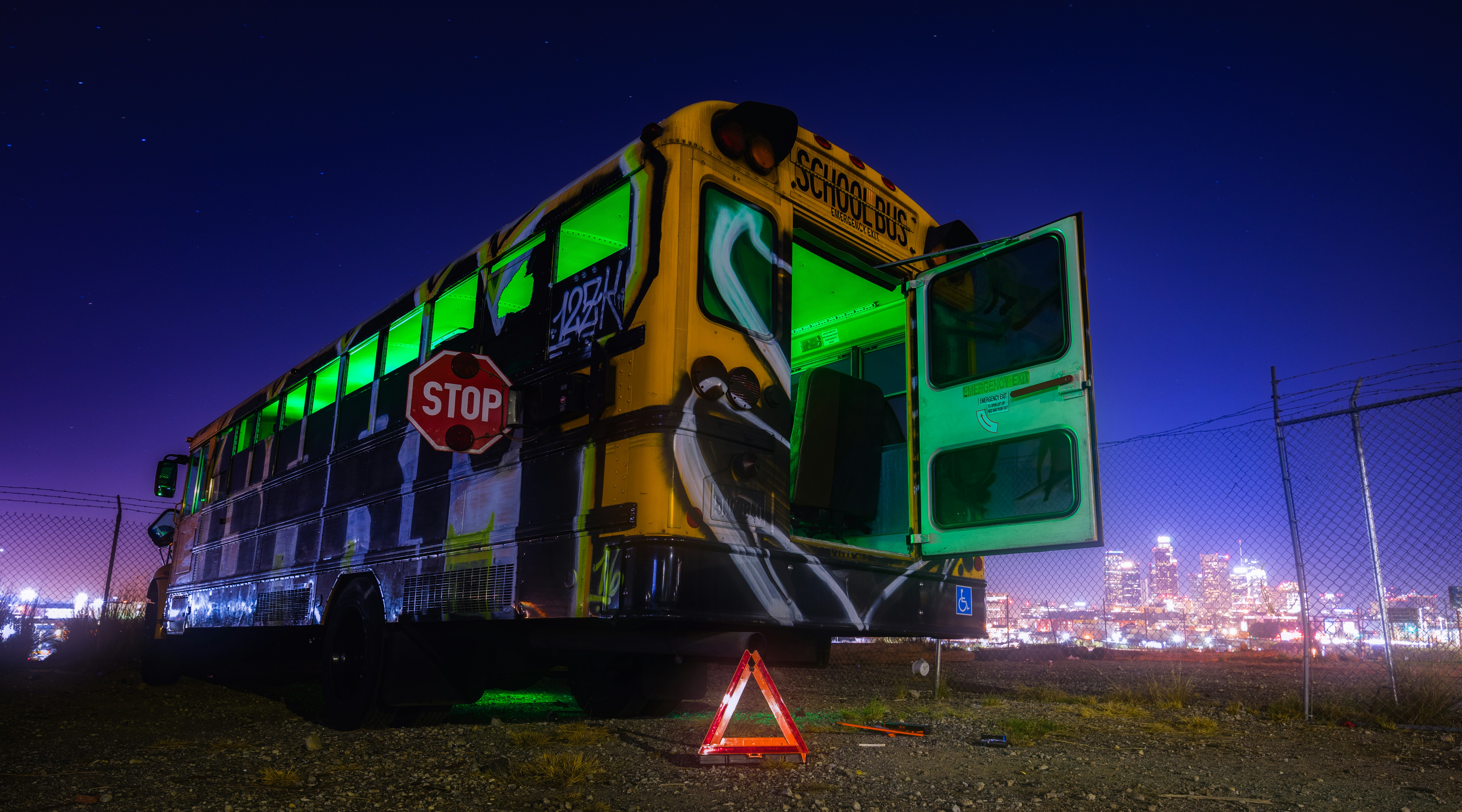 A double decker bus that has been painted green and yellow