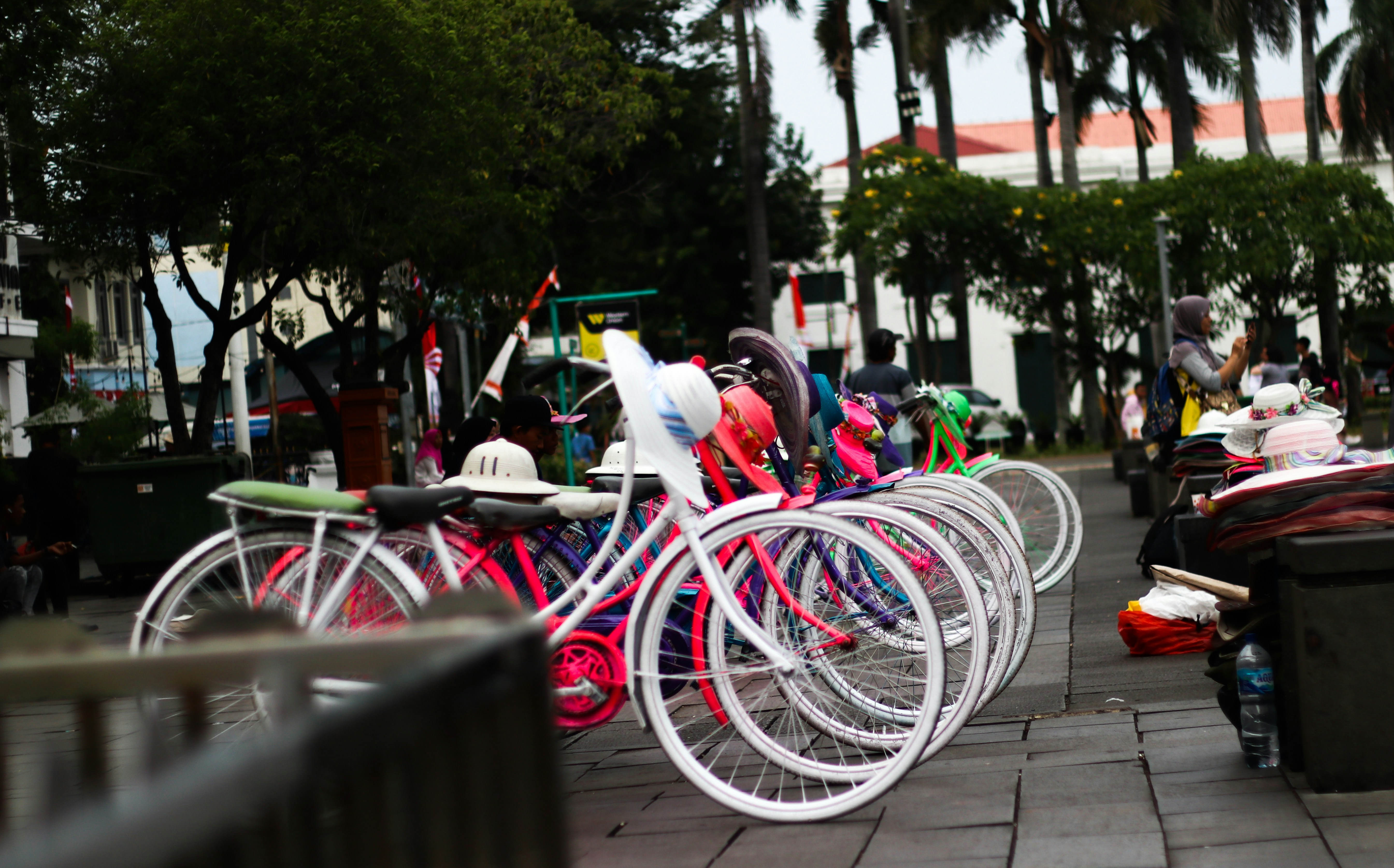 A row of bikes parked next to each other on a sidewalk