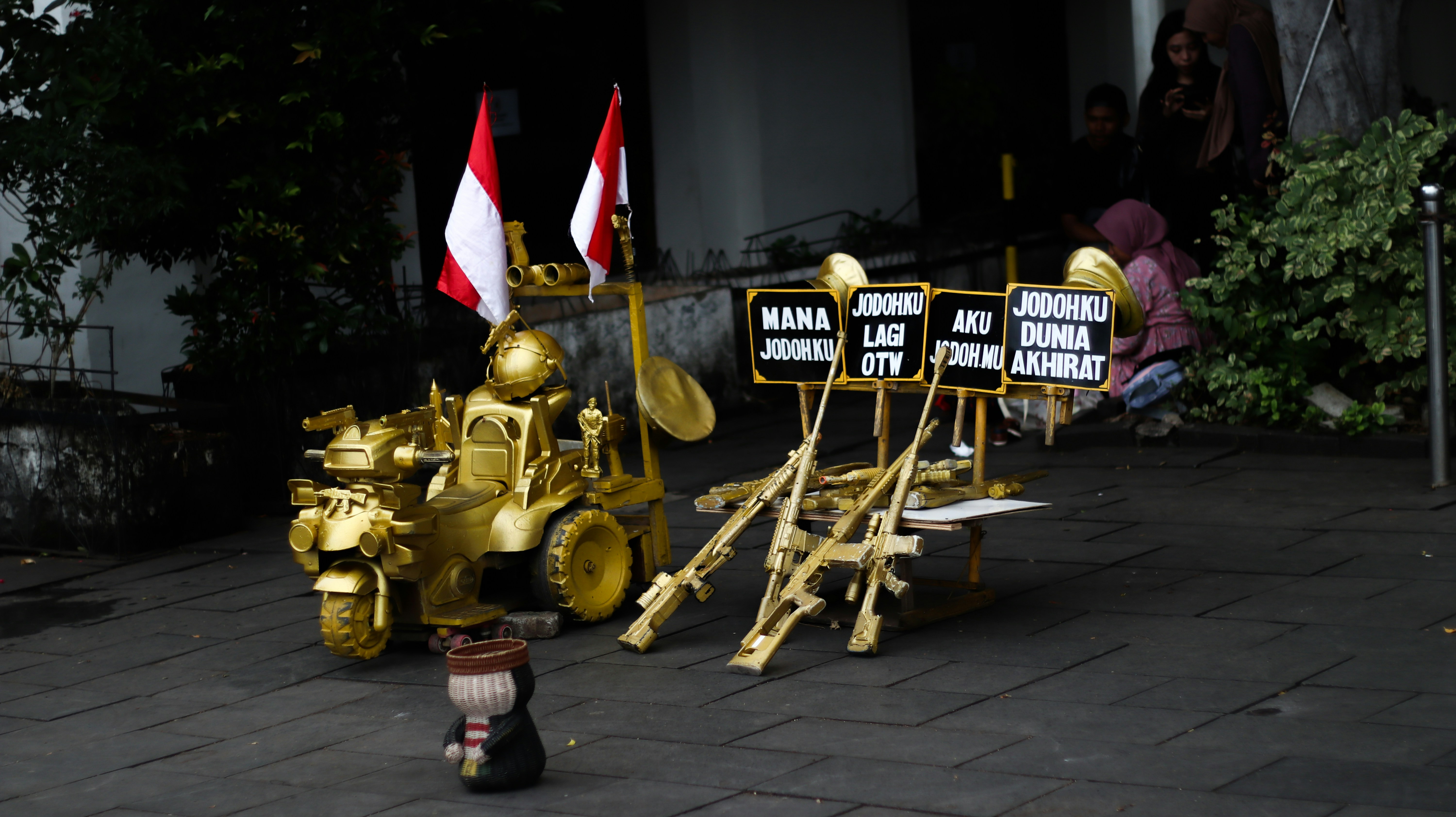 A little girl is standing in front of some yellow equipment