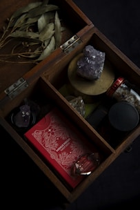 A wooden box filled with different types of items