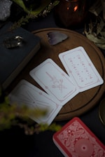 A table topped with cards and a candle