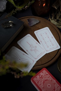 A table topped with cards and a candle
