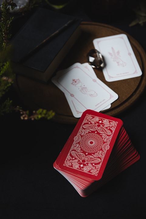 A red playing card sitting on top of a table