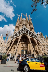 A car parked in front of a very tall building