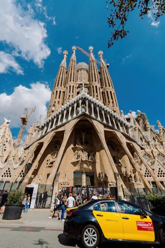 A car parked in front of a very tall building