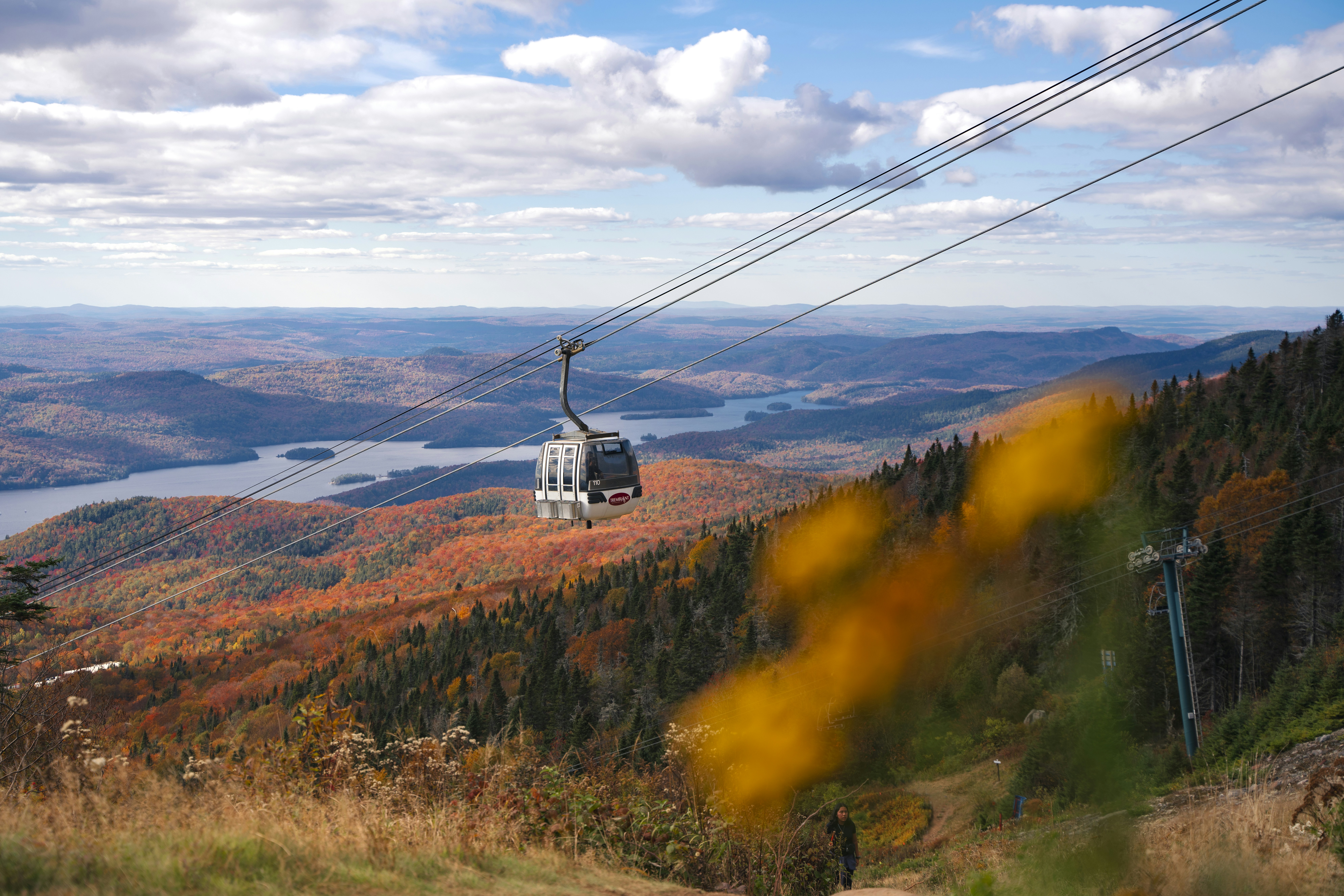 A scenic view of a mountain with a cable car going over it