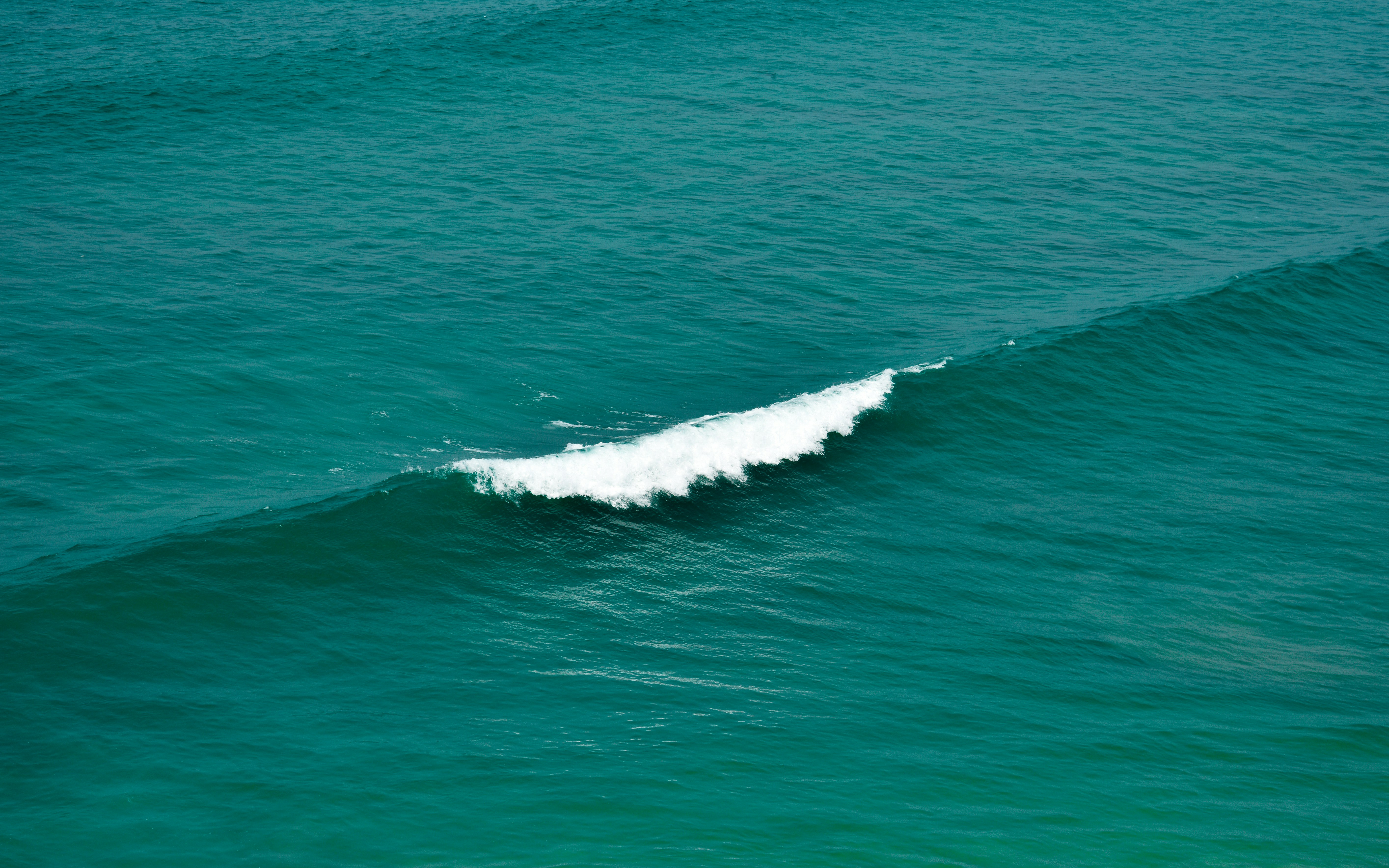 A white surfboard in the middle of the ocean