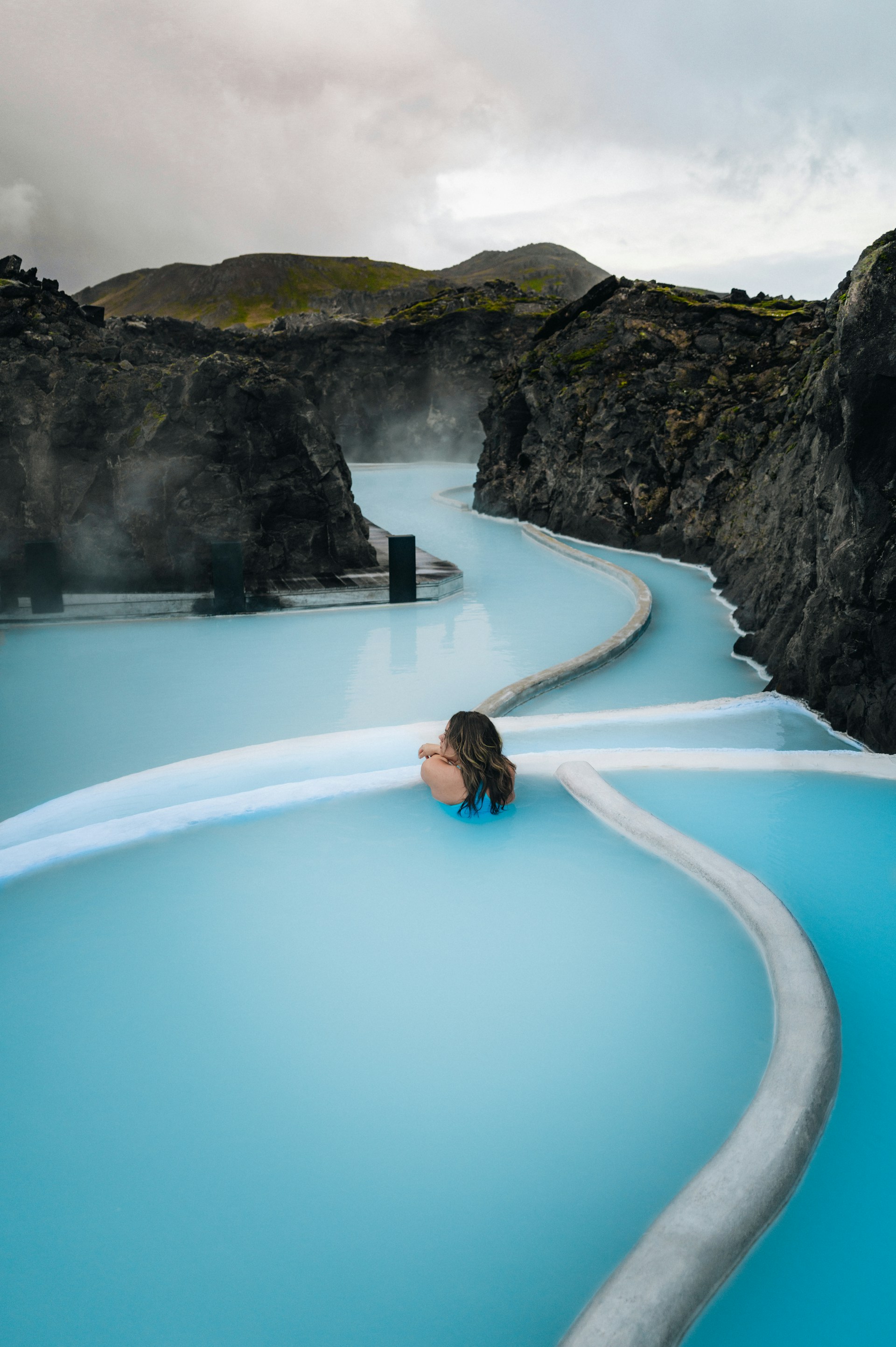 A woman sitting in a pool of blue water