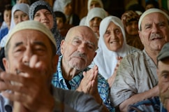 A group of people sitting next to each other