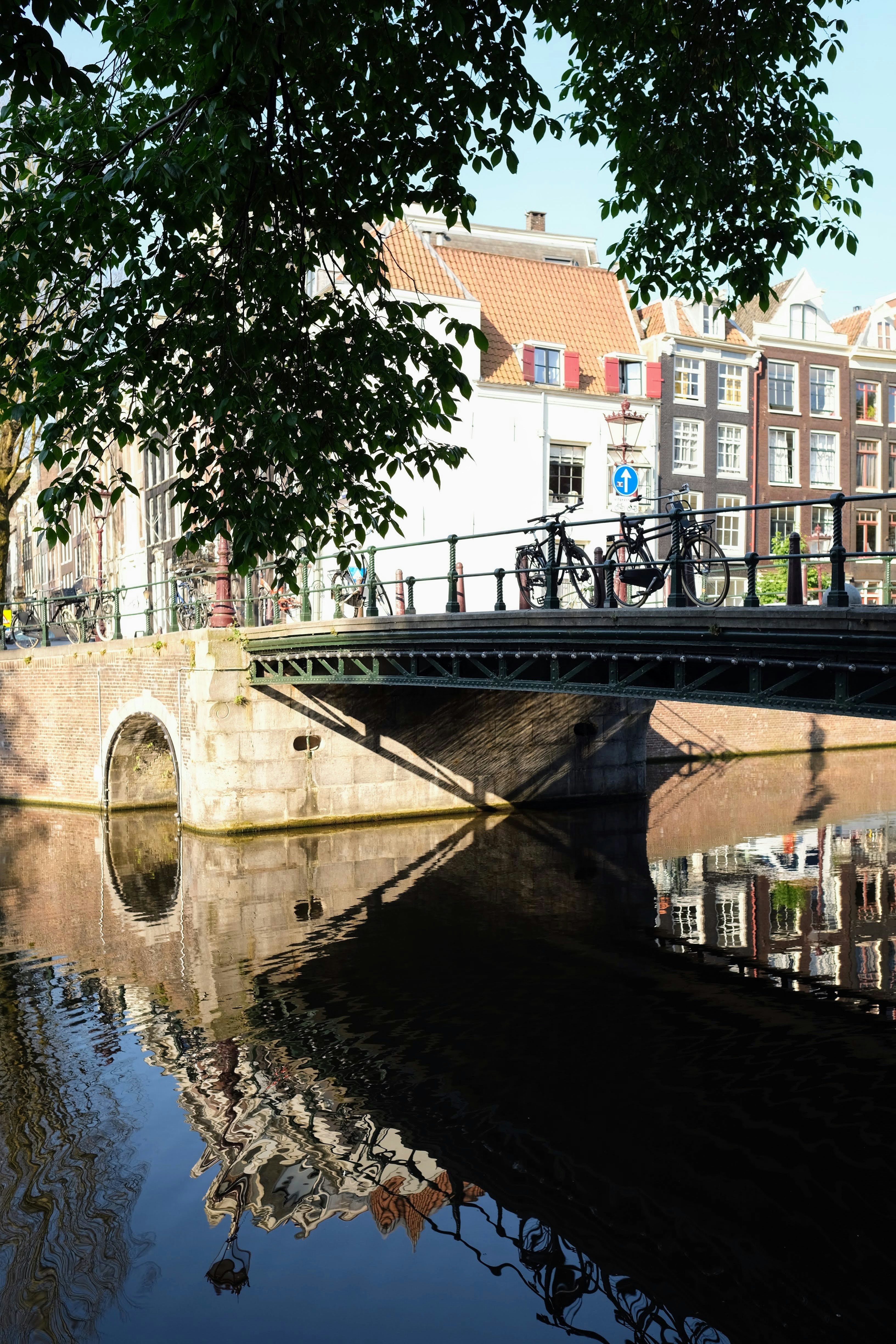A bridge over a body of water with buildings in the background