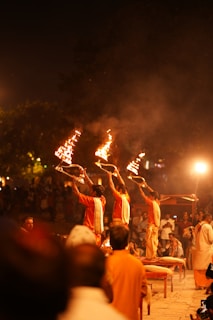 A group of people holding torches in the air