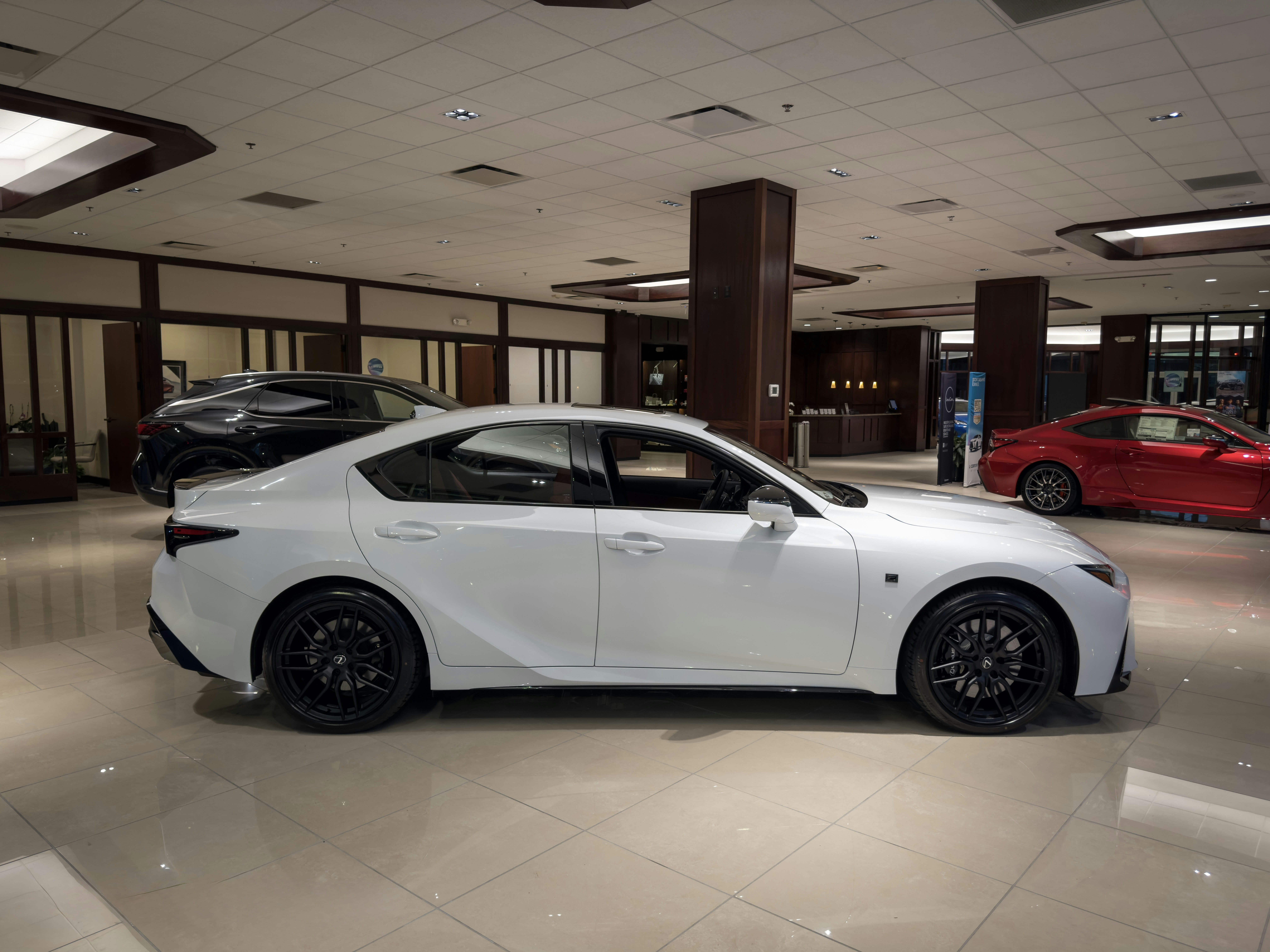 Lexus sedan parked at a dealership showroom, showcasing quality used vehicles available at Marvo Motors
