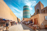 A narrow street with a tall building in the background