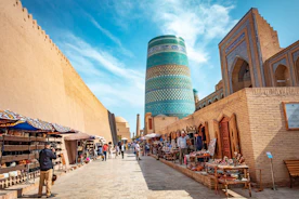 A narrow street with a tall building in the background
