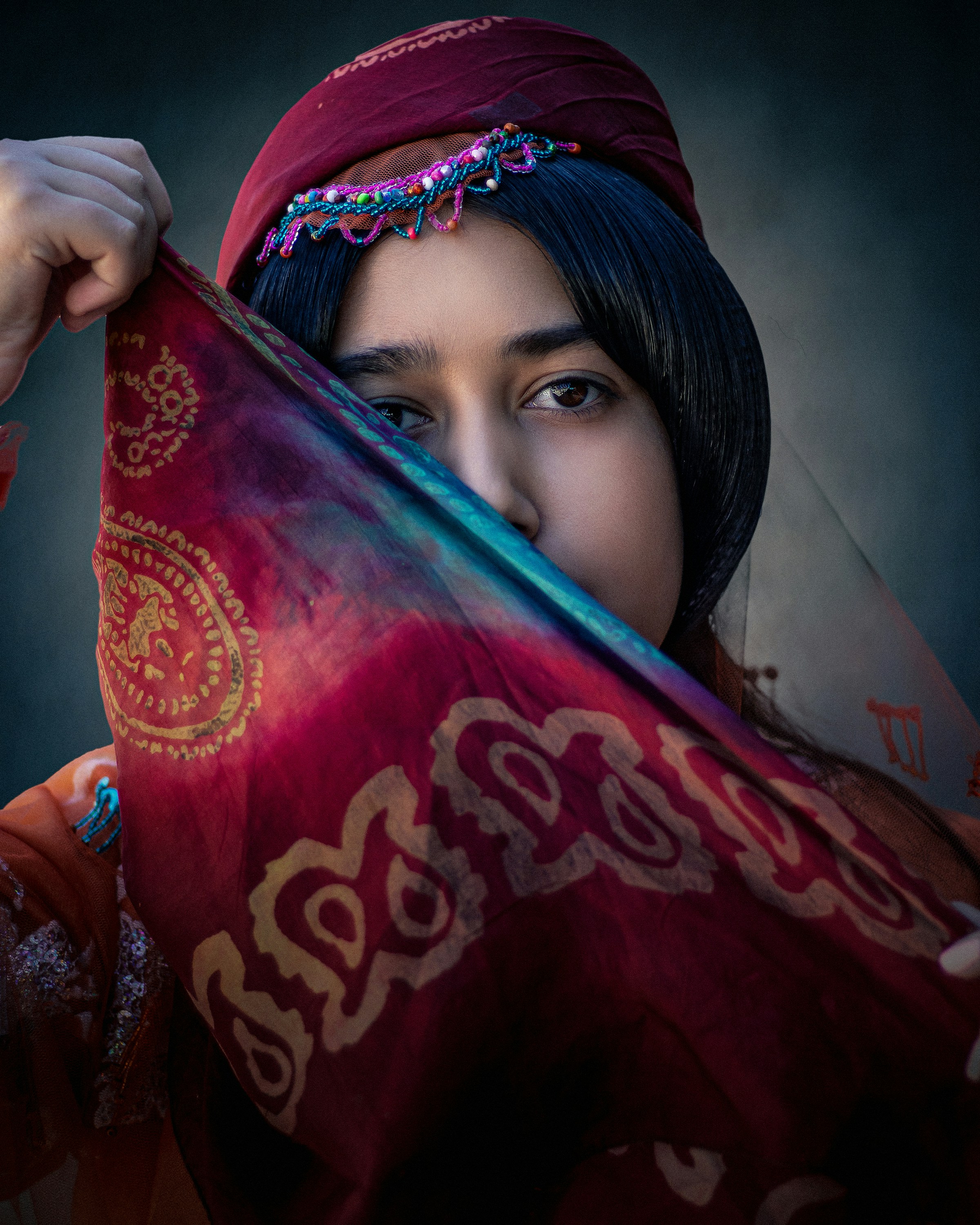 A woman in a red dress holding a red shawl