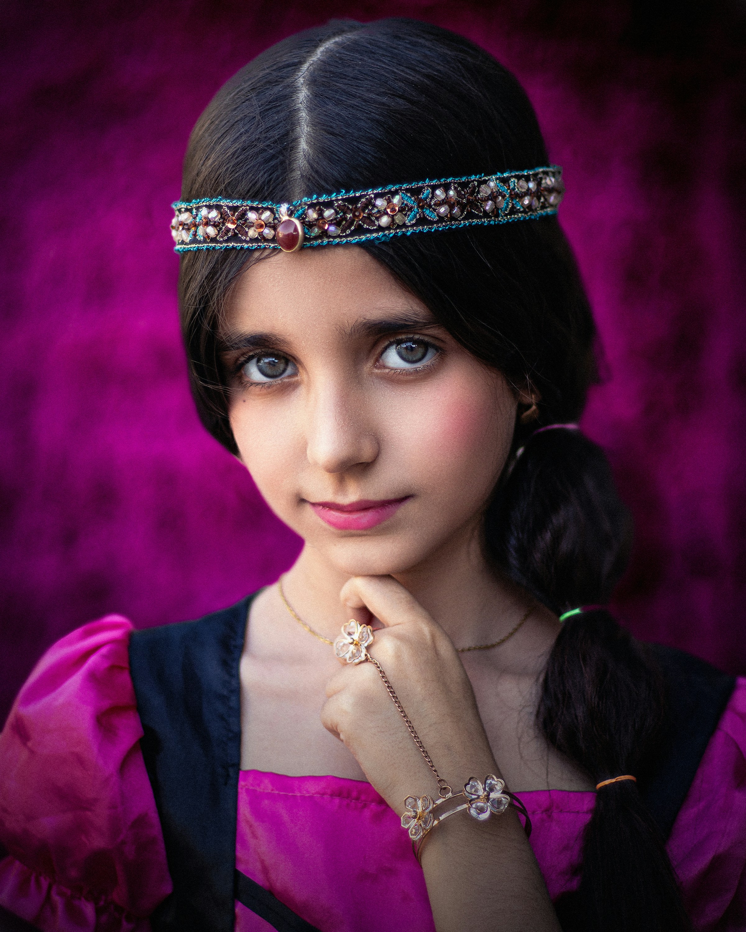 A woman in a purple dress wearing a tiara