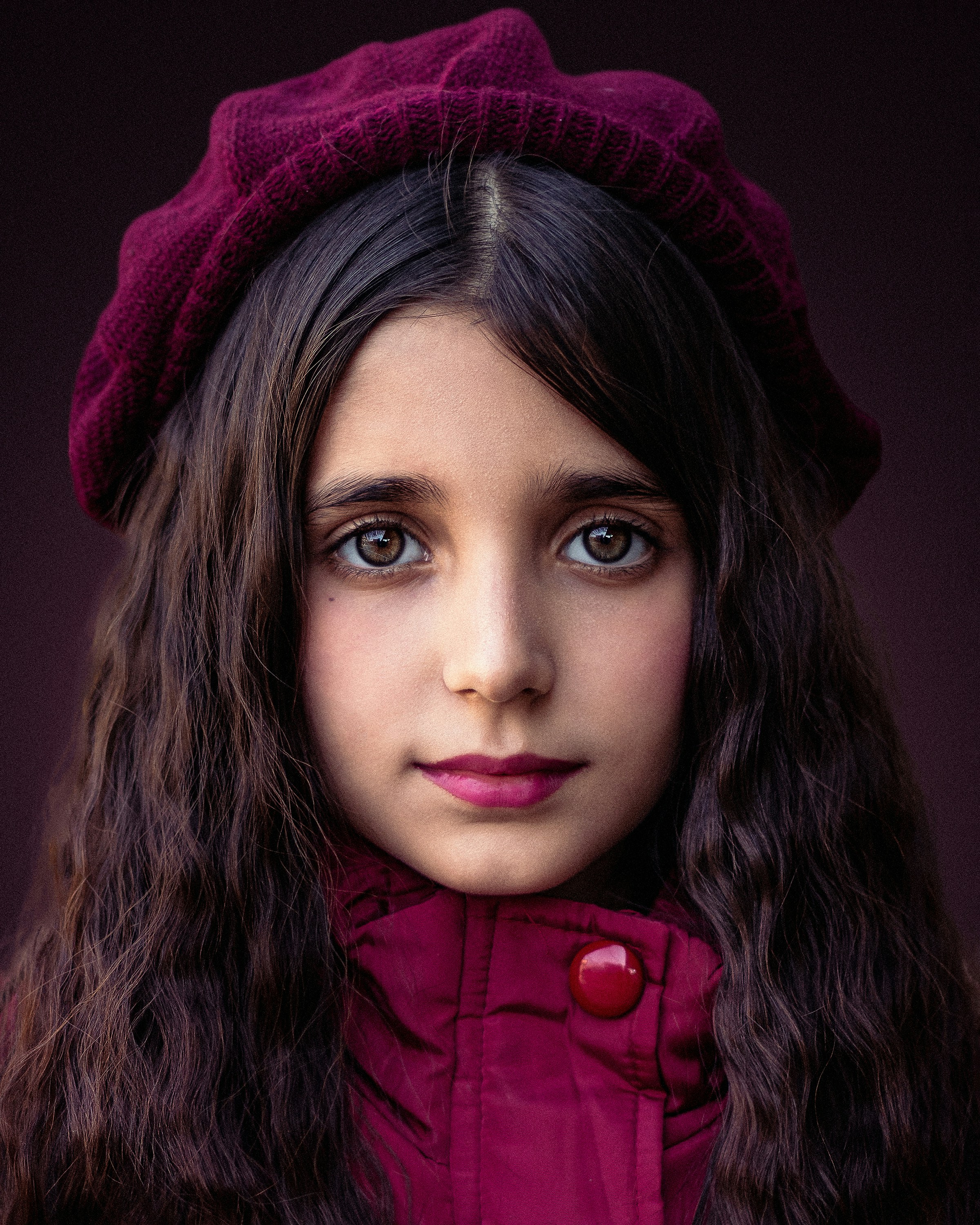 A woman with long hair wearing a red coat