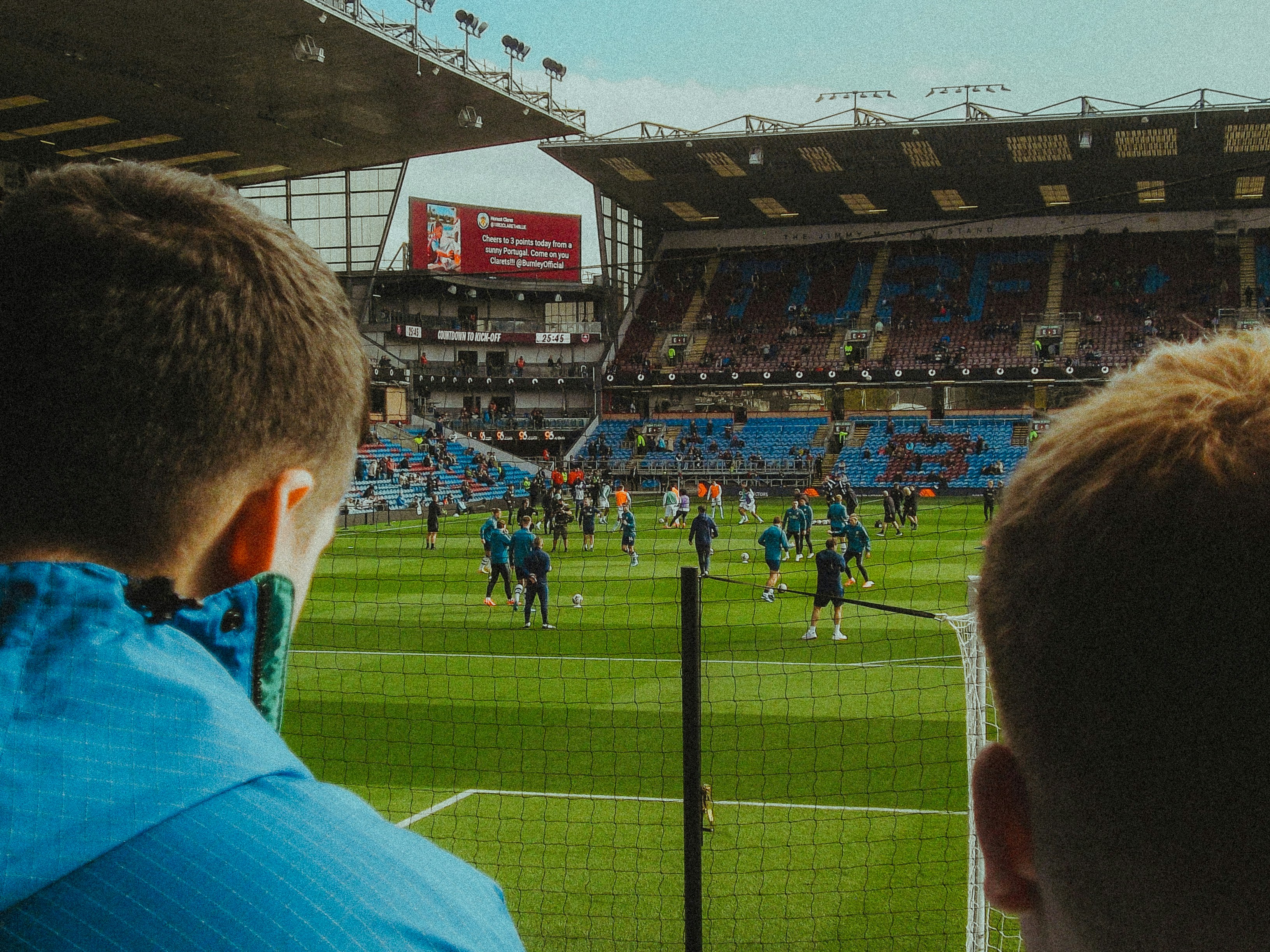 A couple of men standing on top of a soccer field