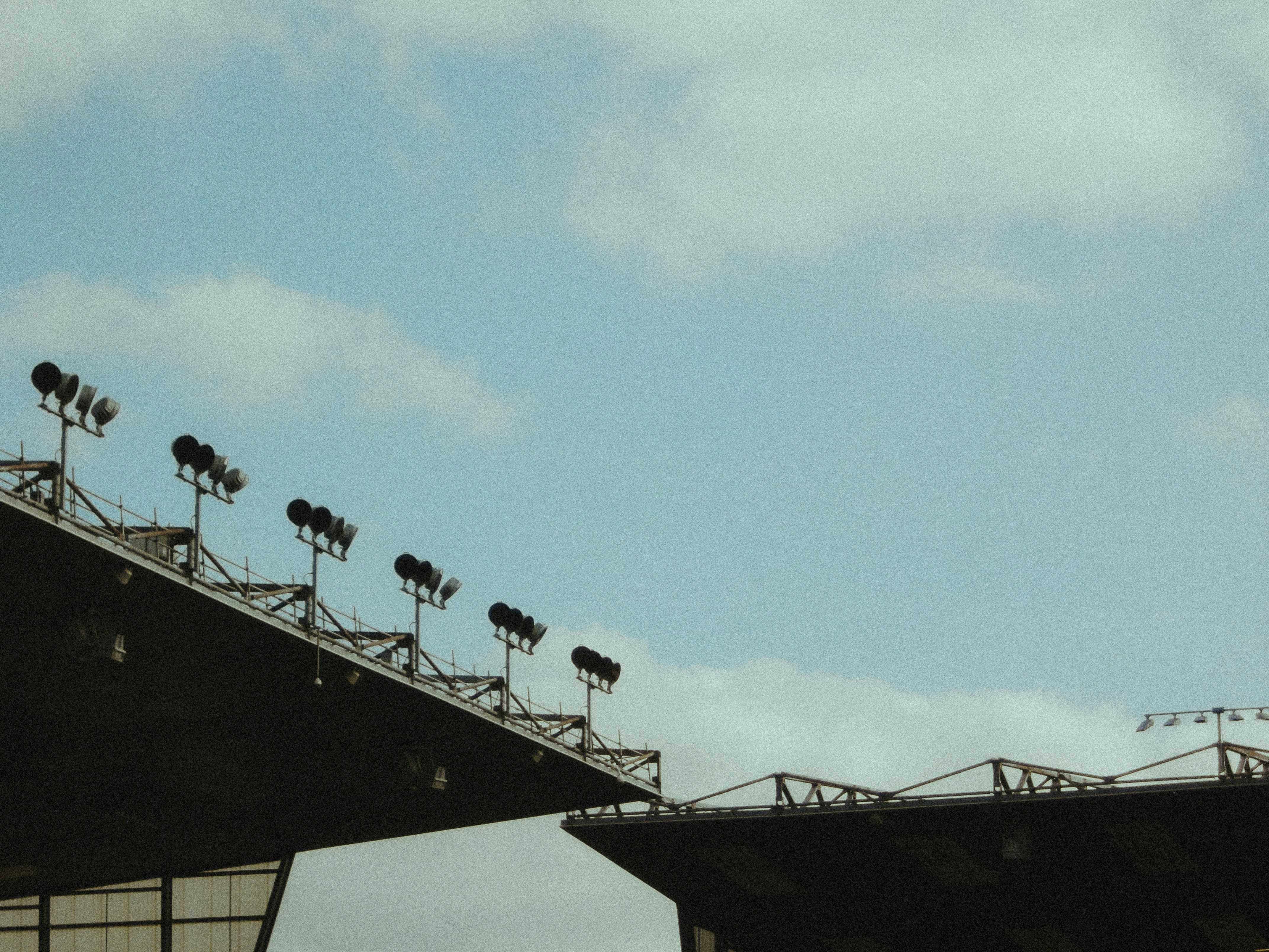 A plane flying over a bridge with lots of lights, 