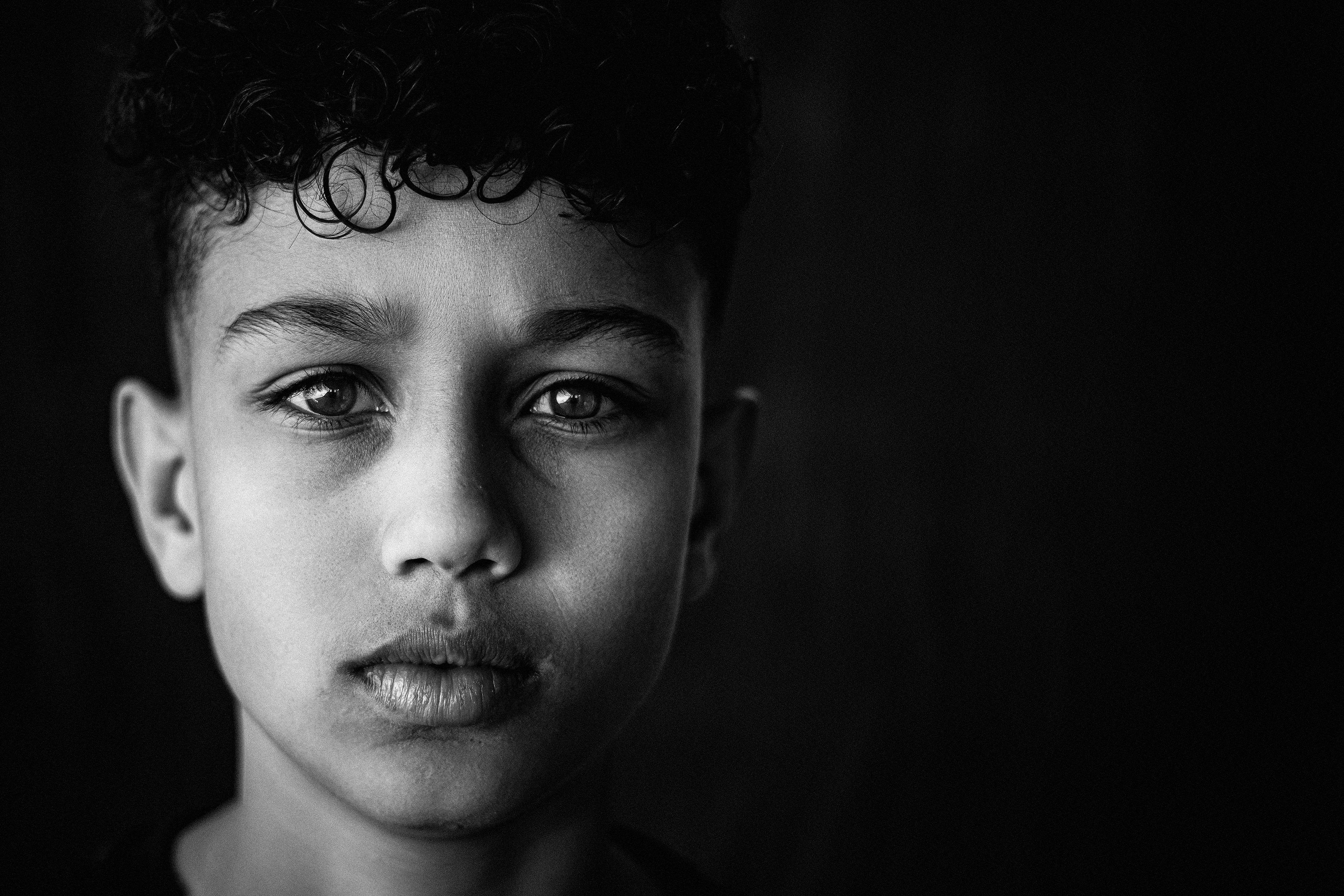 A black and white photo of a young boy
