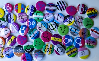 A bunch of different colored buttons on a white surface
