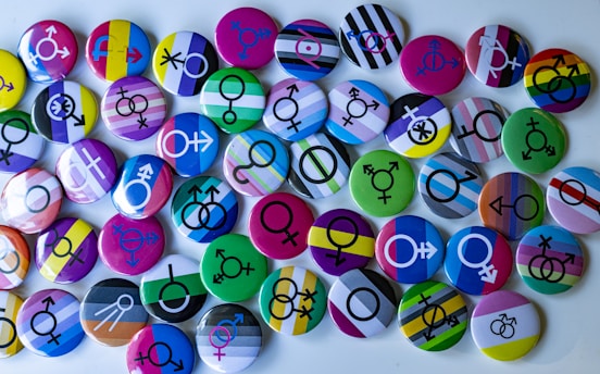 A bunch of different colored buttons on a white surface