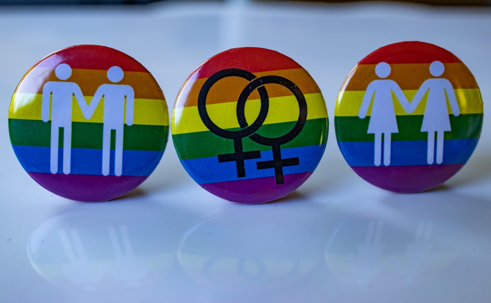 Three pins with a picture of a man and a woman on them